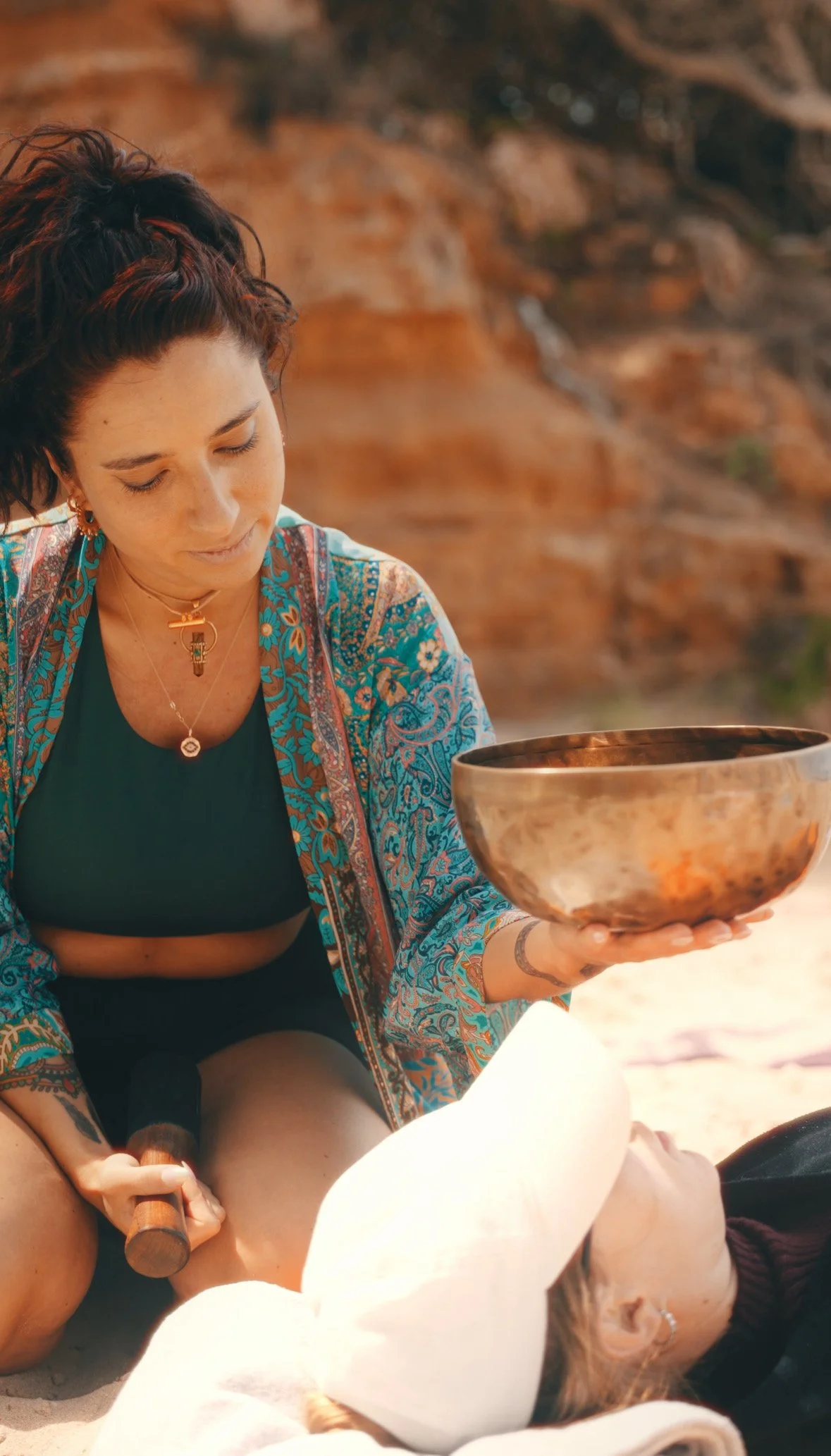 Bella holding a sound and reiki healing session on a beach in Ibiza