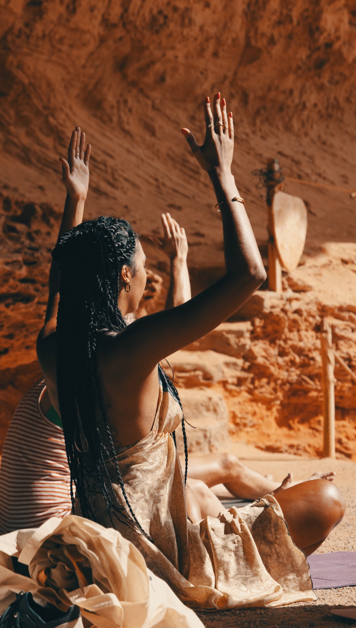 Group practicing a reiki healing meditation and ceremony with Bella in a cave, on a training in Ibiza