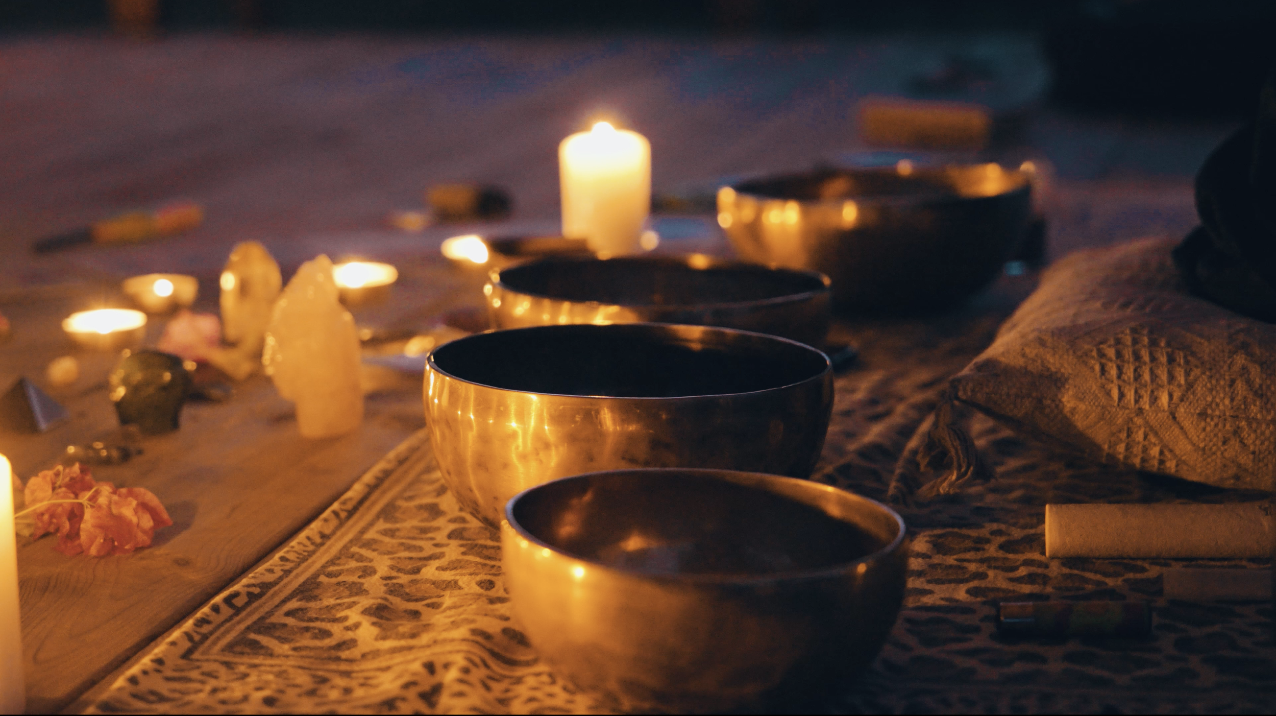 tibetan singing bowls and a healing altar with crystals and candles during a reiki healing training 