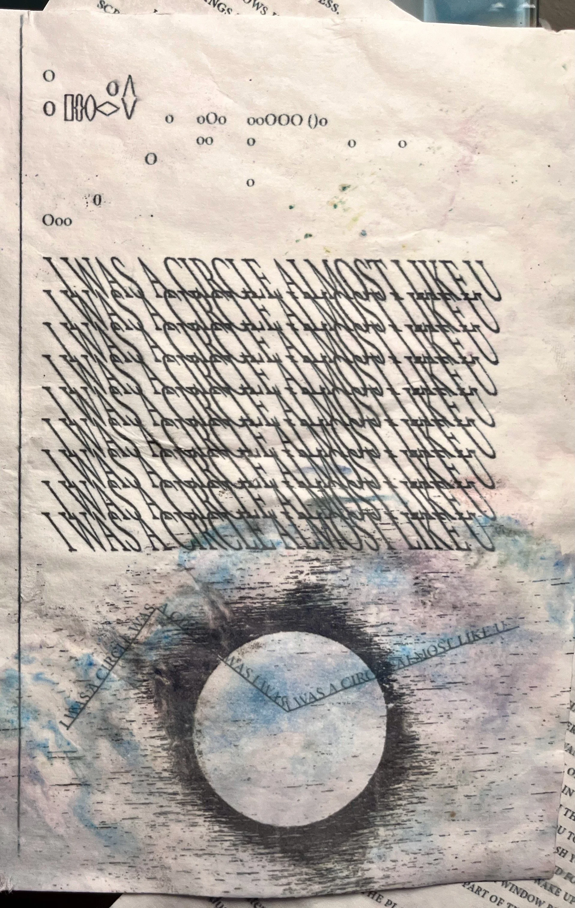 A crumpled, torn piece of paper with an eye-catching design consisting of repeated, overlapping text saying "I WAS A CIRCLE ALMOST LIKE YOU" and various small, different-sized circles and geometric shapes.