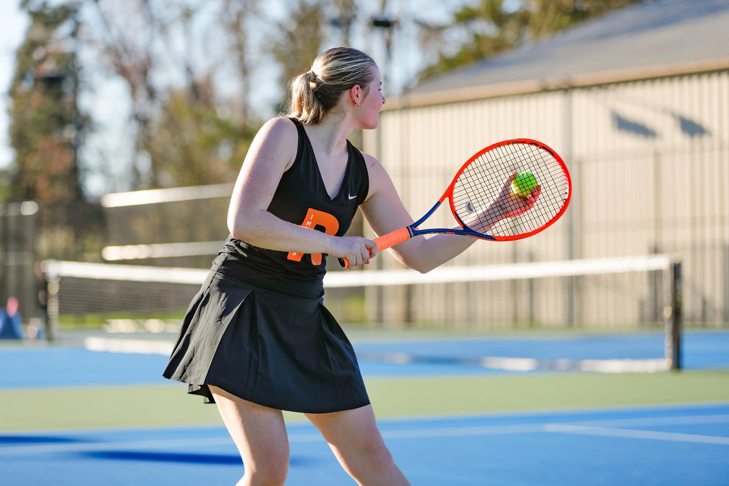 Roseburg high school tennis player on an outdoor court at UVTC