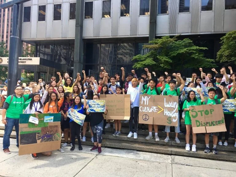 VietLead members holding signs with phrases such as "My culture > Luxury Housing" and "Stop Displacement."