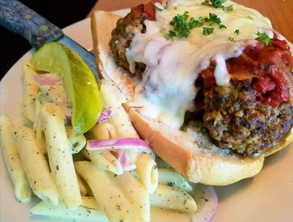 Our meatball parmigiana hoagie is a delicious and satisfying dinner choice. It's stuffed with homemade meatballs and marinara sauce and topped with mozzarella &amp; parmesan cheese. #beaufortsc