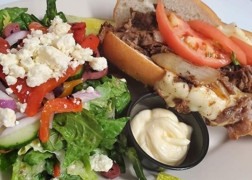 Our cheesesteak hoagie with a fresh Mediterranean salad make a great lunch pair. We're open until 3pm on Mondays.