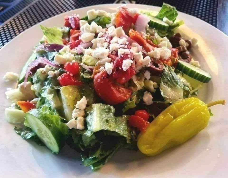 Looking for a light lunch? Our Mediterranean salad is BIG on taste with feta, oil-cured olives, red onion, cucumber, pepperocini, roasted red peppers and fire roasted tomatoes...topped with a tasty Greek vinaigrette. 🥗 #beaufortsc #eatlocal