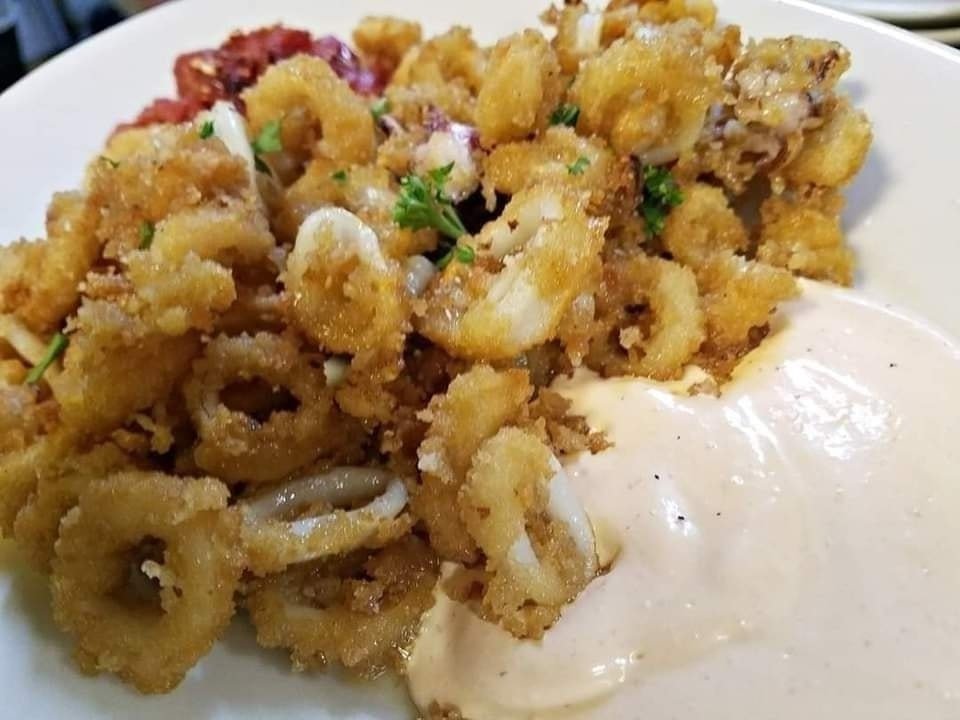 Our calamari is a delicious start to your dinner. It's almond-crusted and served with a spicy aioli, a spicy marinara sauce, and burnt honey. #eatlocal #beaufortsc