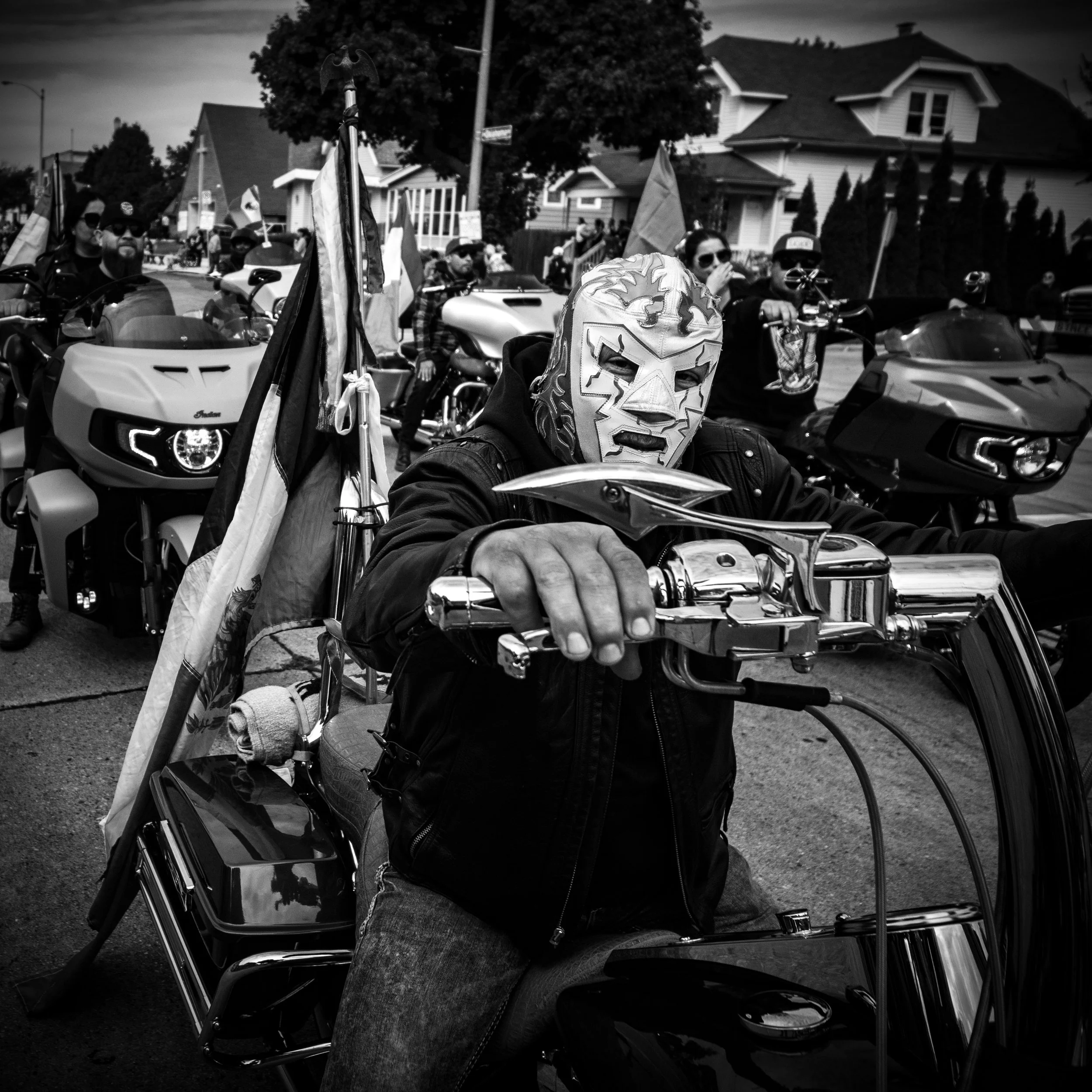 Street photo of a man wearing a Mexican wrestling mask on a Harley Davidson on the southside of milwaukee  