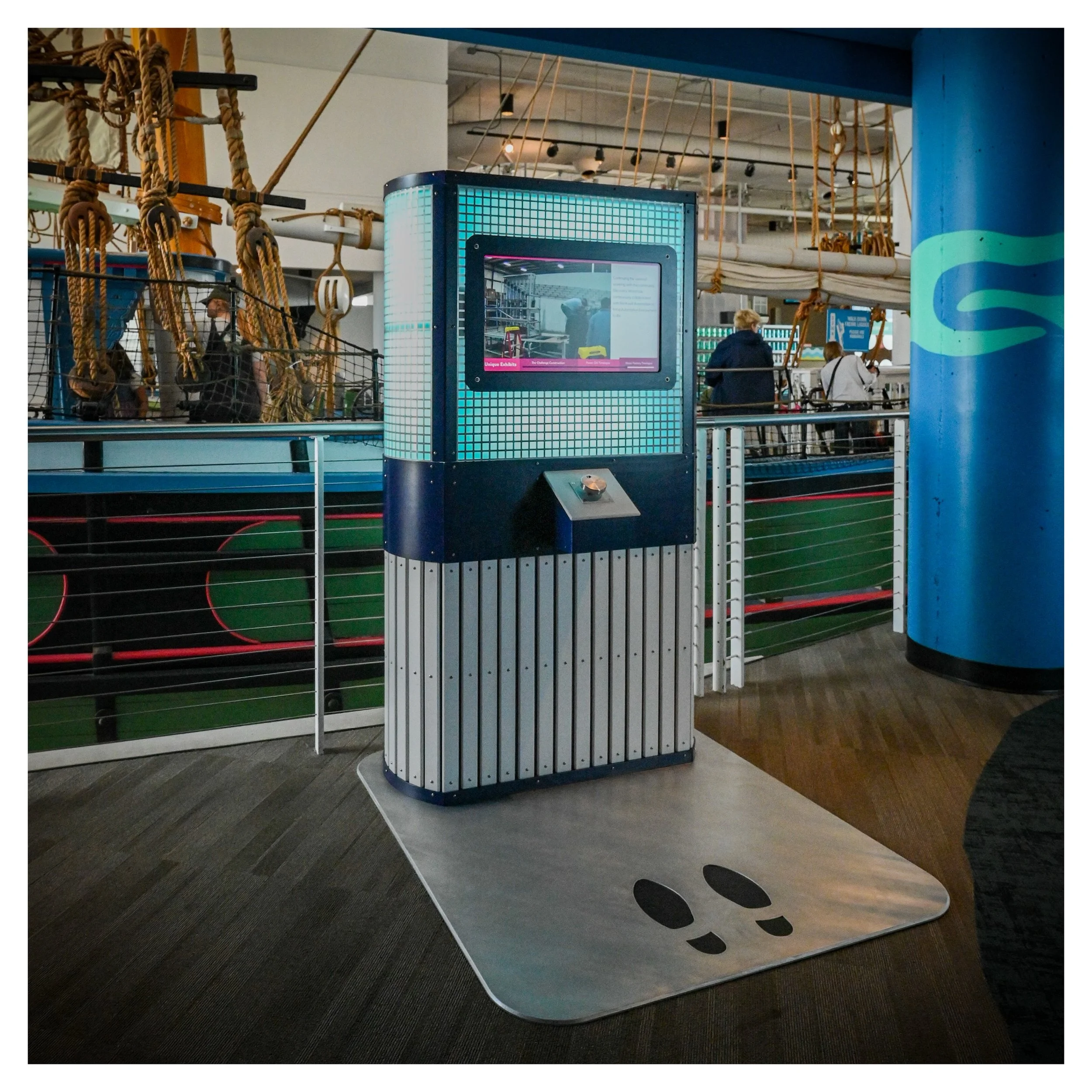 Interactive kiosks with multi layered materials and internally lit glowing panels
