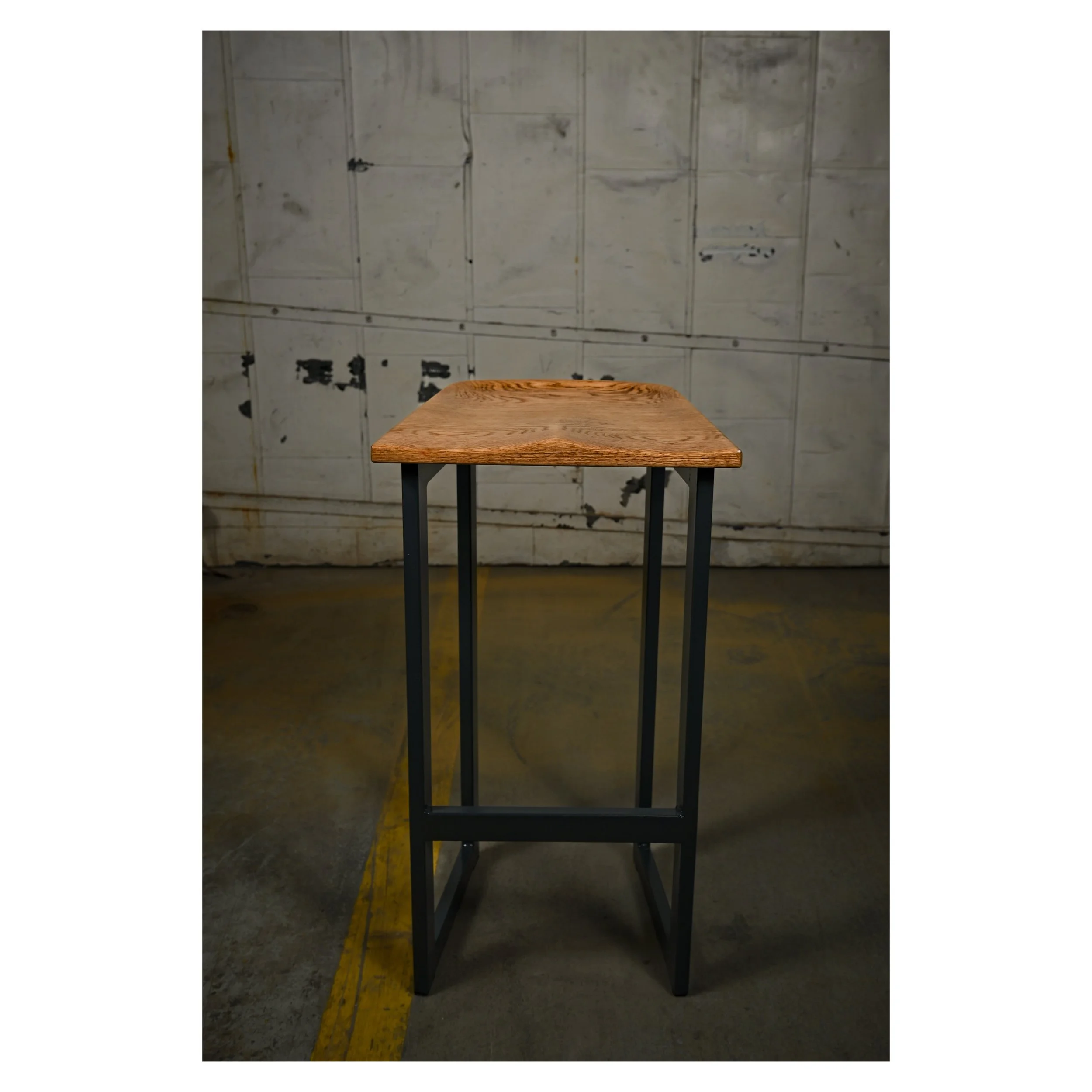 Contemporary designed bar stool with hand carved sculpted chair seat and slim minimal steal legs 