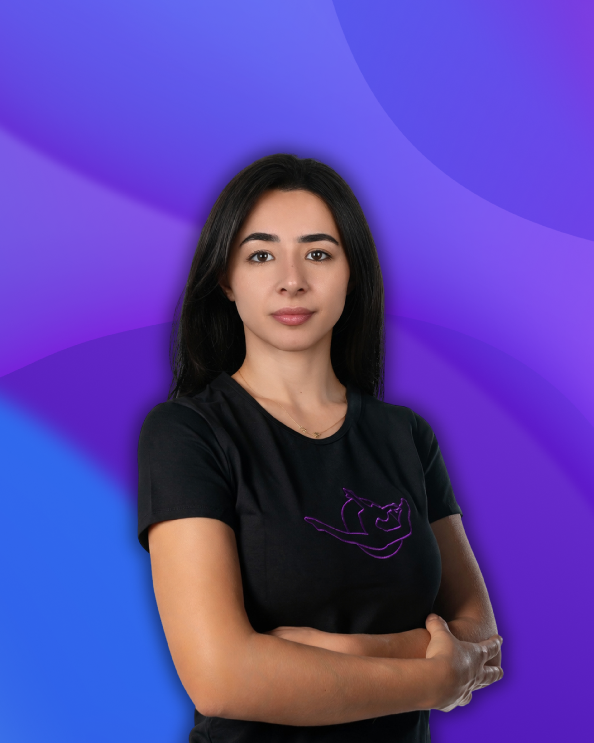 A young woman with dark hair and a natural makeup look standing in front of a purple and blue gradient background, wearing a black T-shirt with a neon pink graphic design, and crossing her arms.