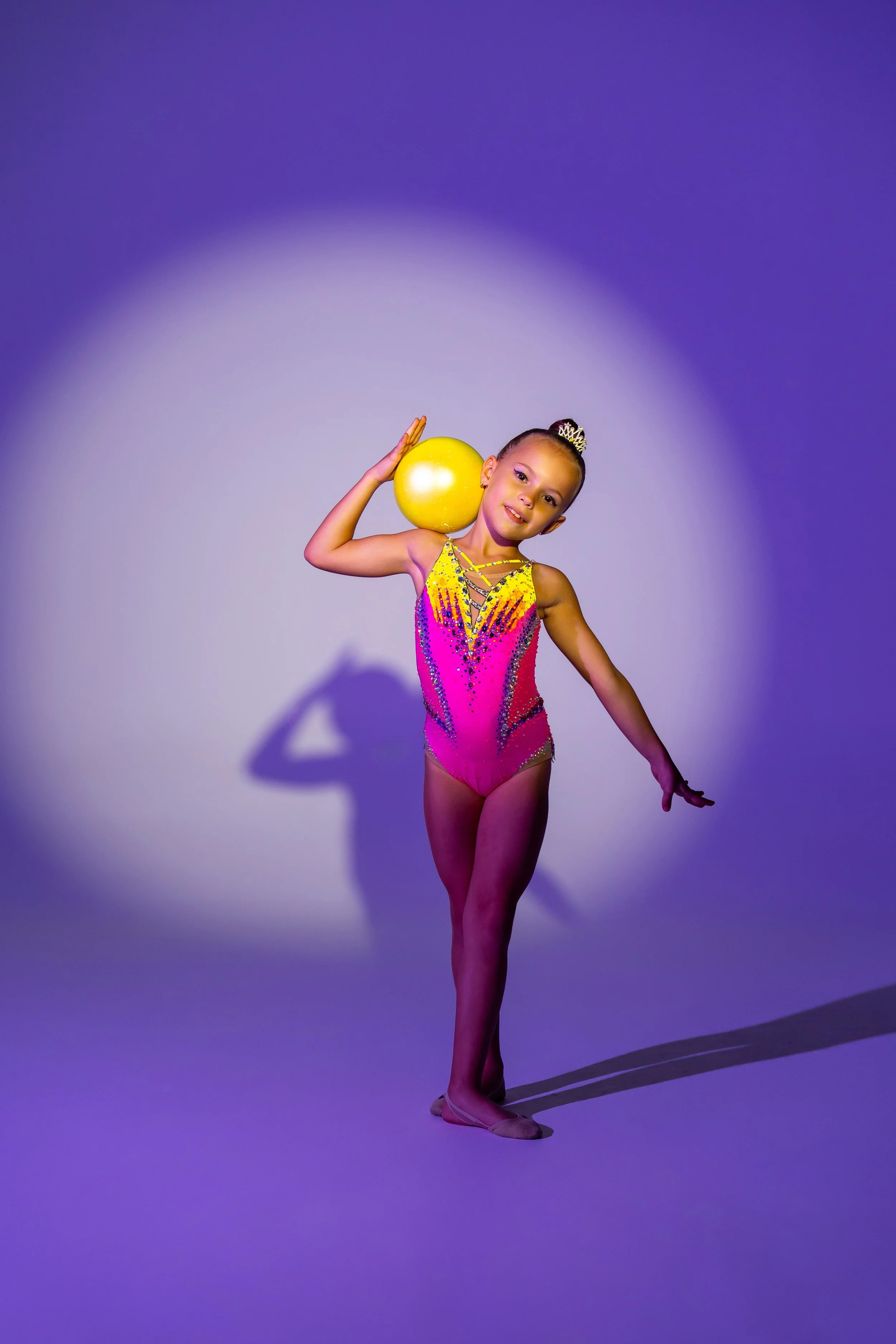Coach Sveta Rhythmic Gymnastics Club gymnast in Dubai posing with a rhythmic gymnastics ball in a professional competition leotard.