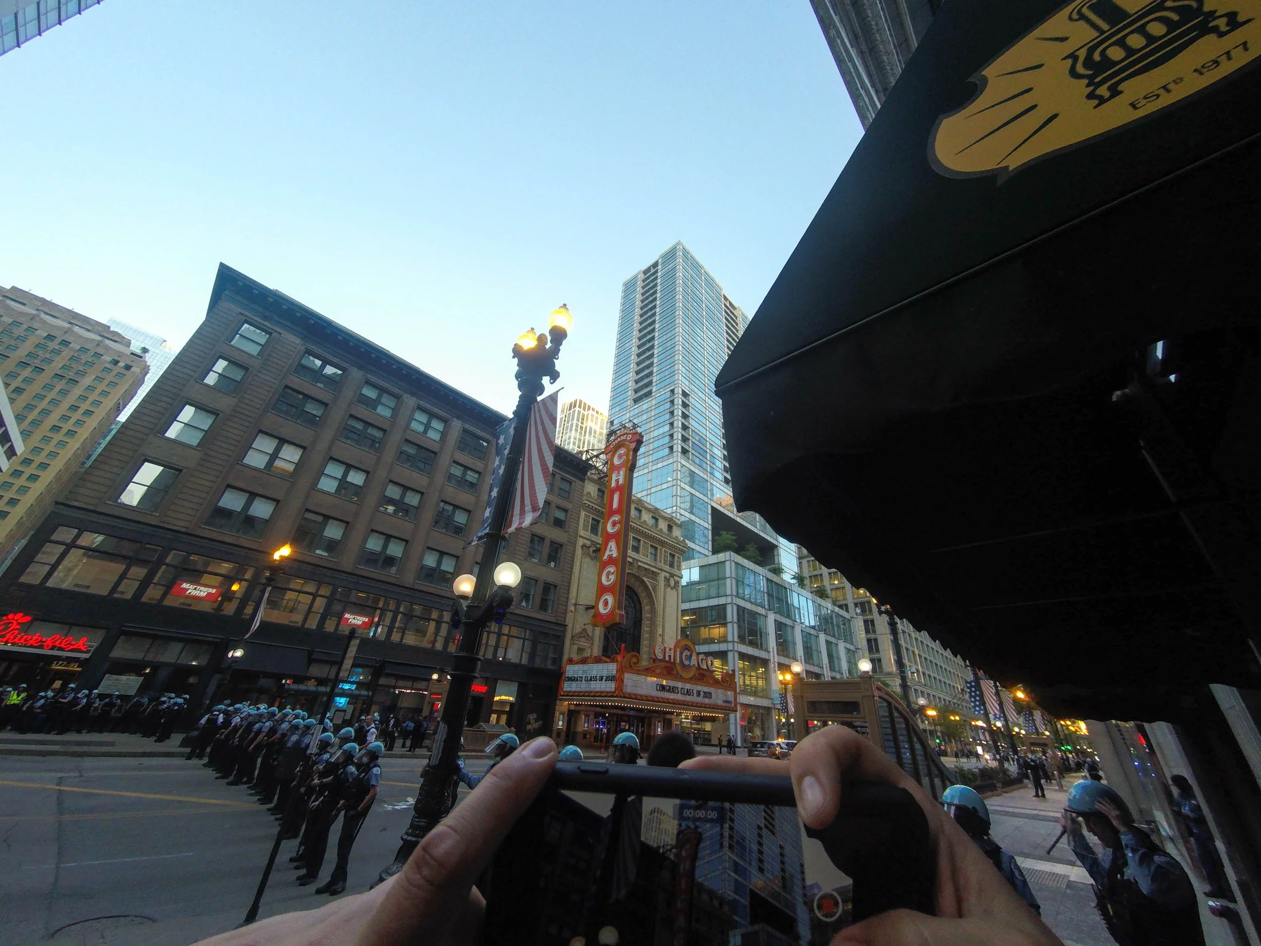 I filmed the "Congratulations Graduates of 2020" sign on the Chicago Theater and the cops who were all huddled together scared, and of course ready to beat some ass if at all possible.  