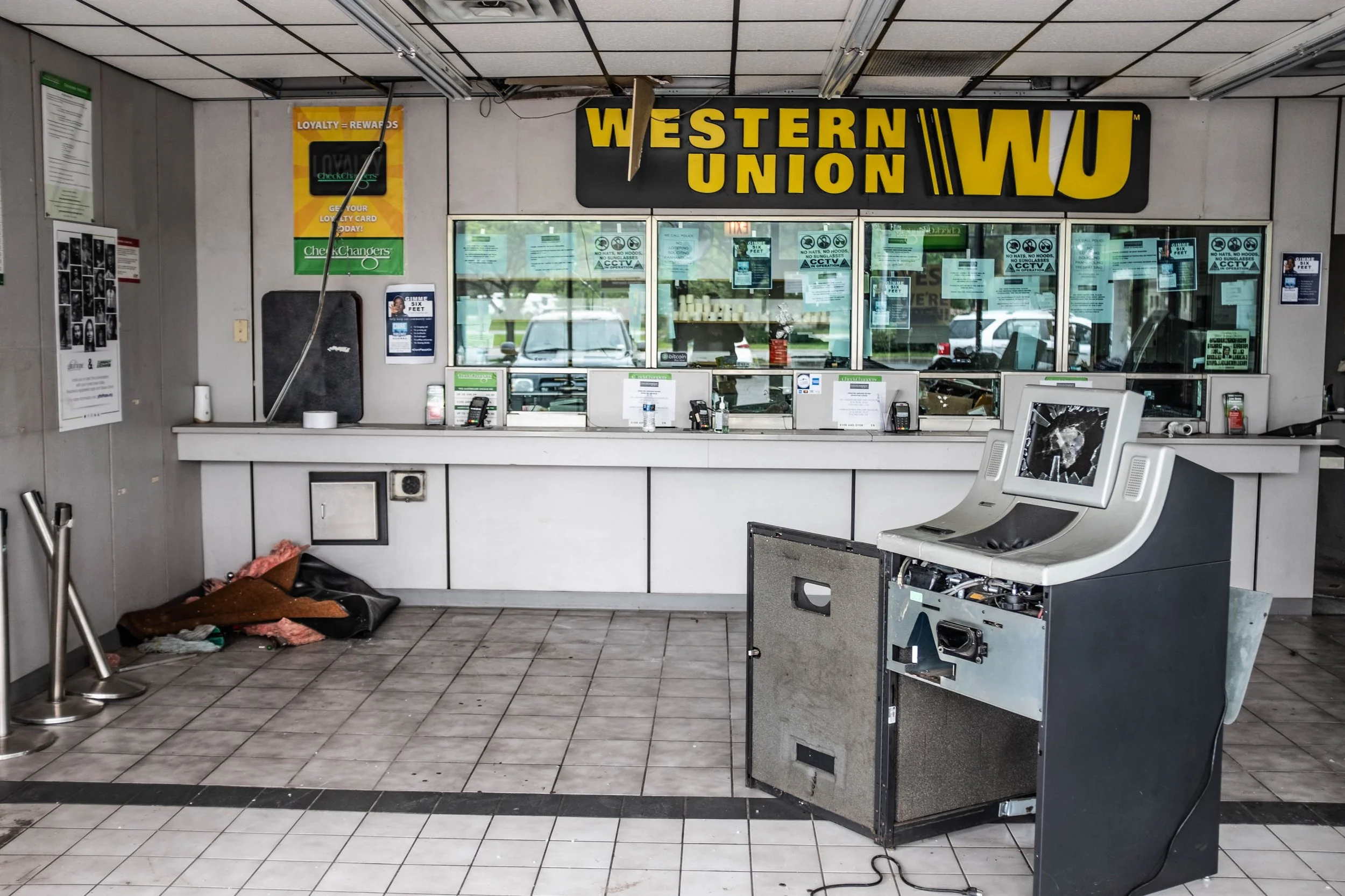 My next stop was to check out Grand Boulevard Plaza mall again. That was the mall with lines of cars looting it the night before. I parked my truck in front of the Western Union and went snooping around in there. I wondered if the looters really had 