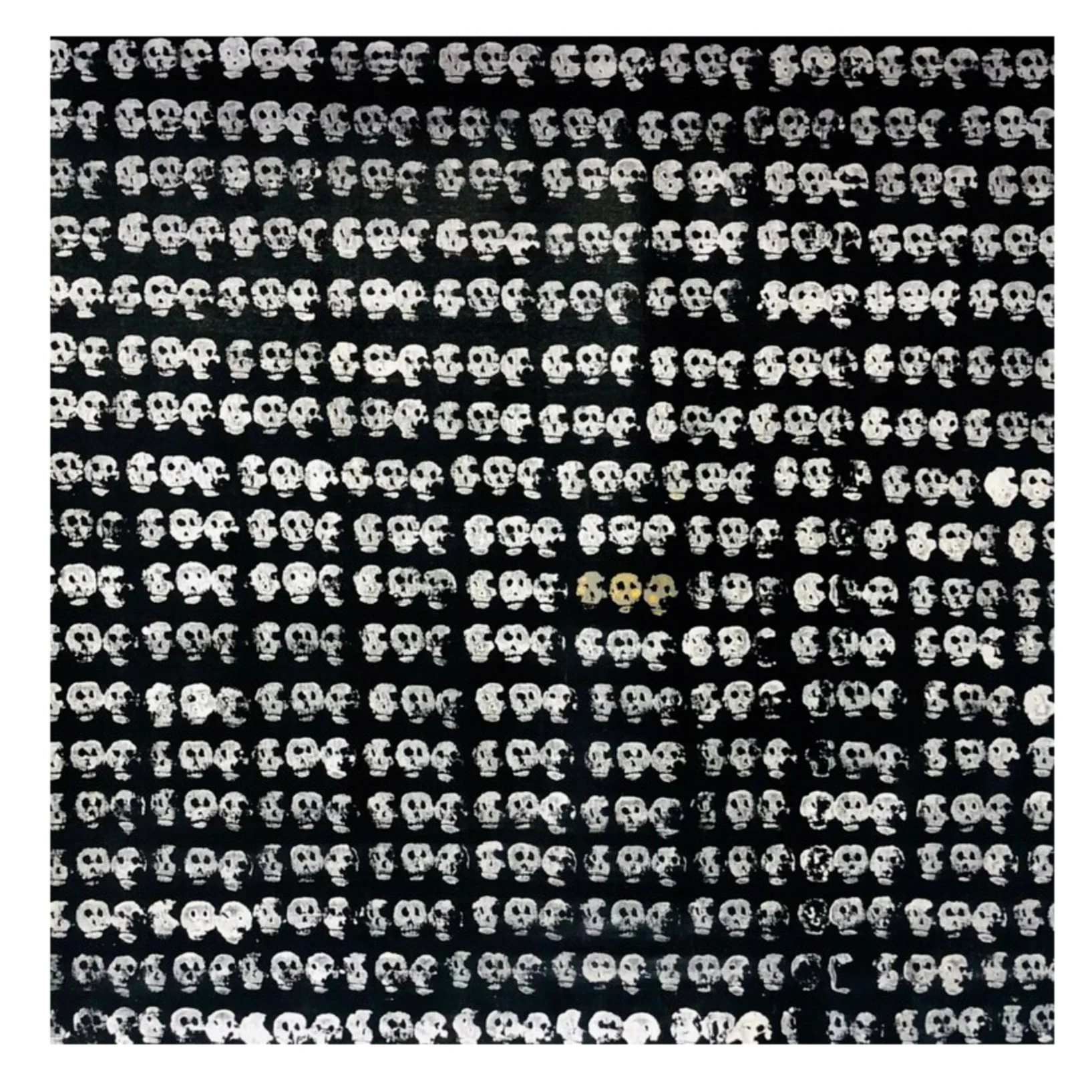 Pattern of small white skulls on a black background with a few gold-colored skulls in the center.