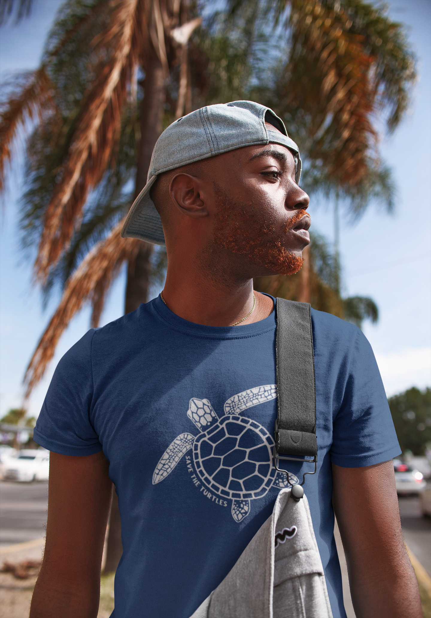 t-shirt-mockup-of-a-man-with-overalls-standing-in-front-of-a-palm-tree-22399.png