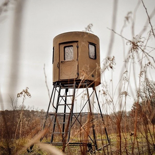 Box blind on a steel tower at the edge of a field