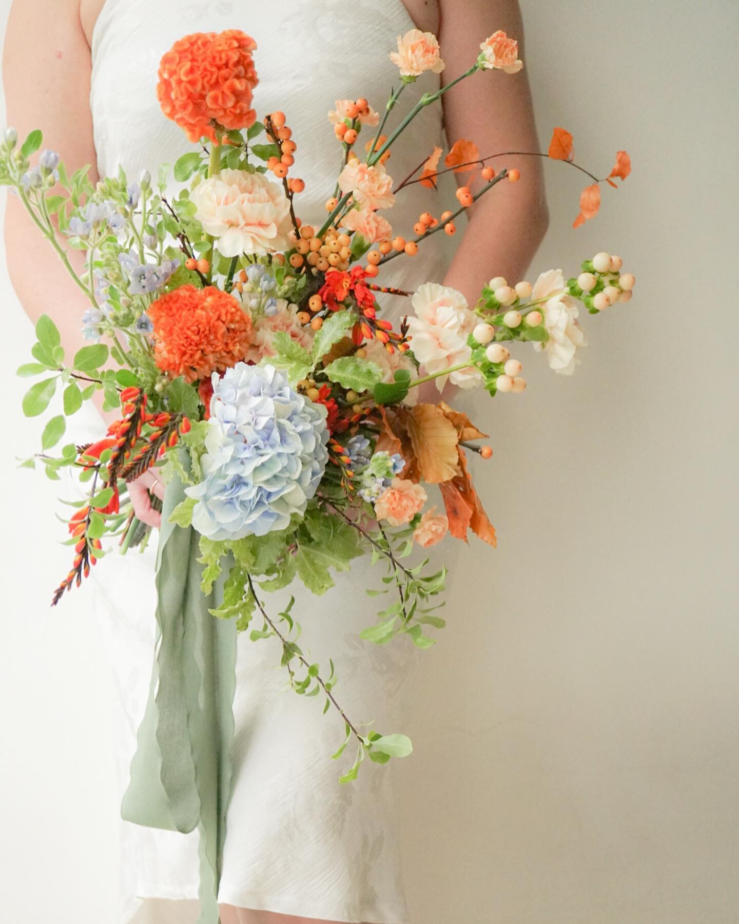 Pastel blue and a pop of orange, spring meadow style for Alethea &amp; Nigel. 

This one&rsquo;s especially meaningful bcos our flowers have been part of their celebrations since they first started dating. The gradual intensification of peach shades 