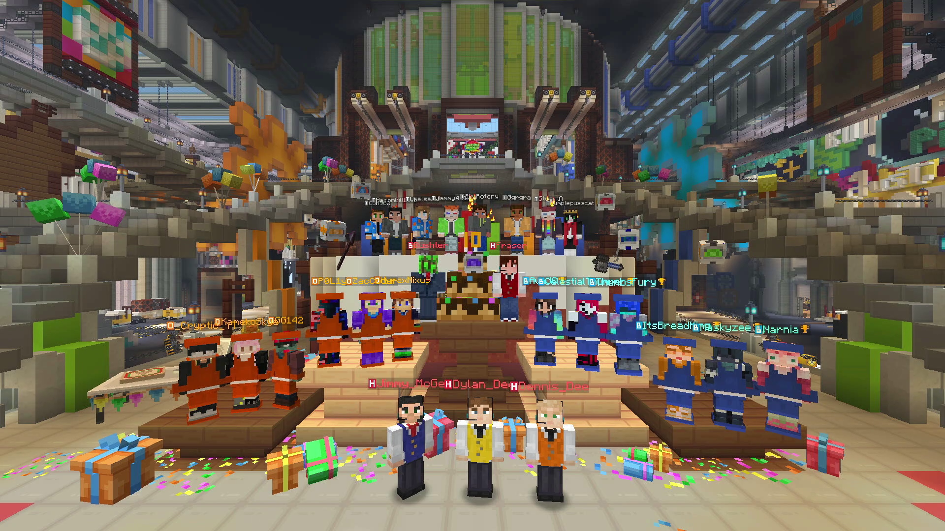 An in-game screenshot from Gameshow Showdown. Inside the factory front door, players gather in front of a large birthday cake with the number 10 made of candles sticking out of the top.