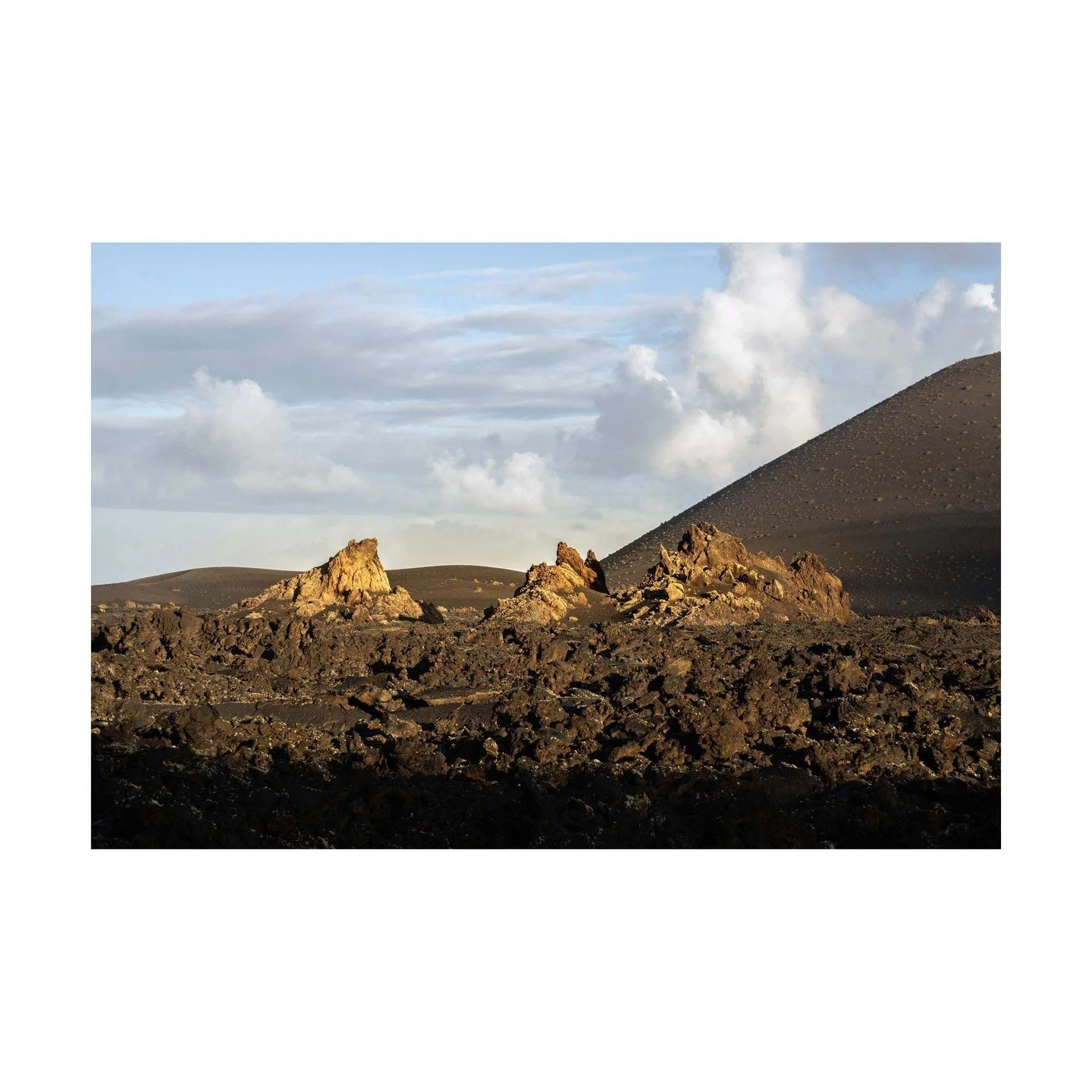 🌋 A Volcanic Triptych: Three Eruptions 🌋
These jagged formations are the remnants of three distinct eruptions, standing like a natural triptych against the Lanzarote sky. Each peak tells its own story of volcanic power, shaping this surreal landsca