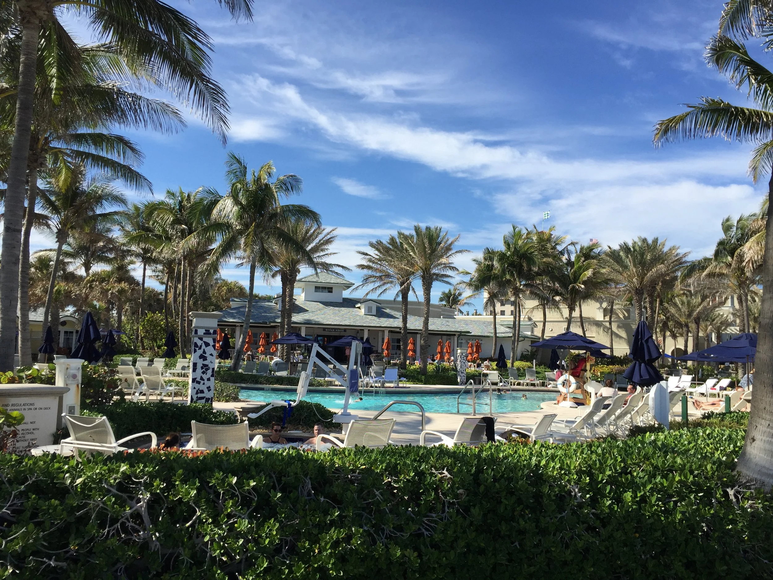One of the pools at the Breakers with a view of the restaurant behind it