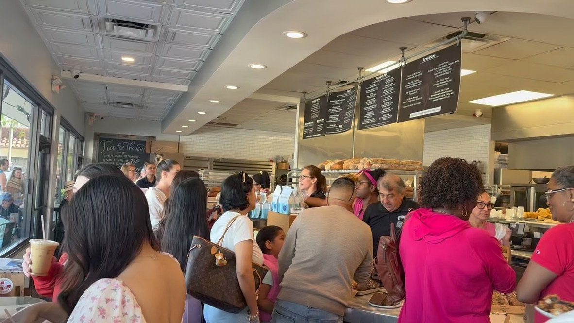 People ordering at the counter at Aioli in West Palm Beach. The photos shows how busy and popular Aioli is