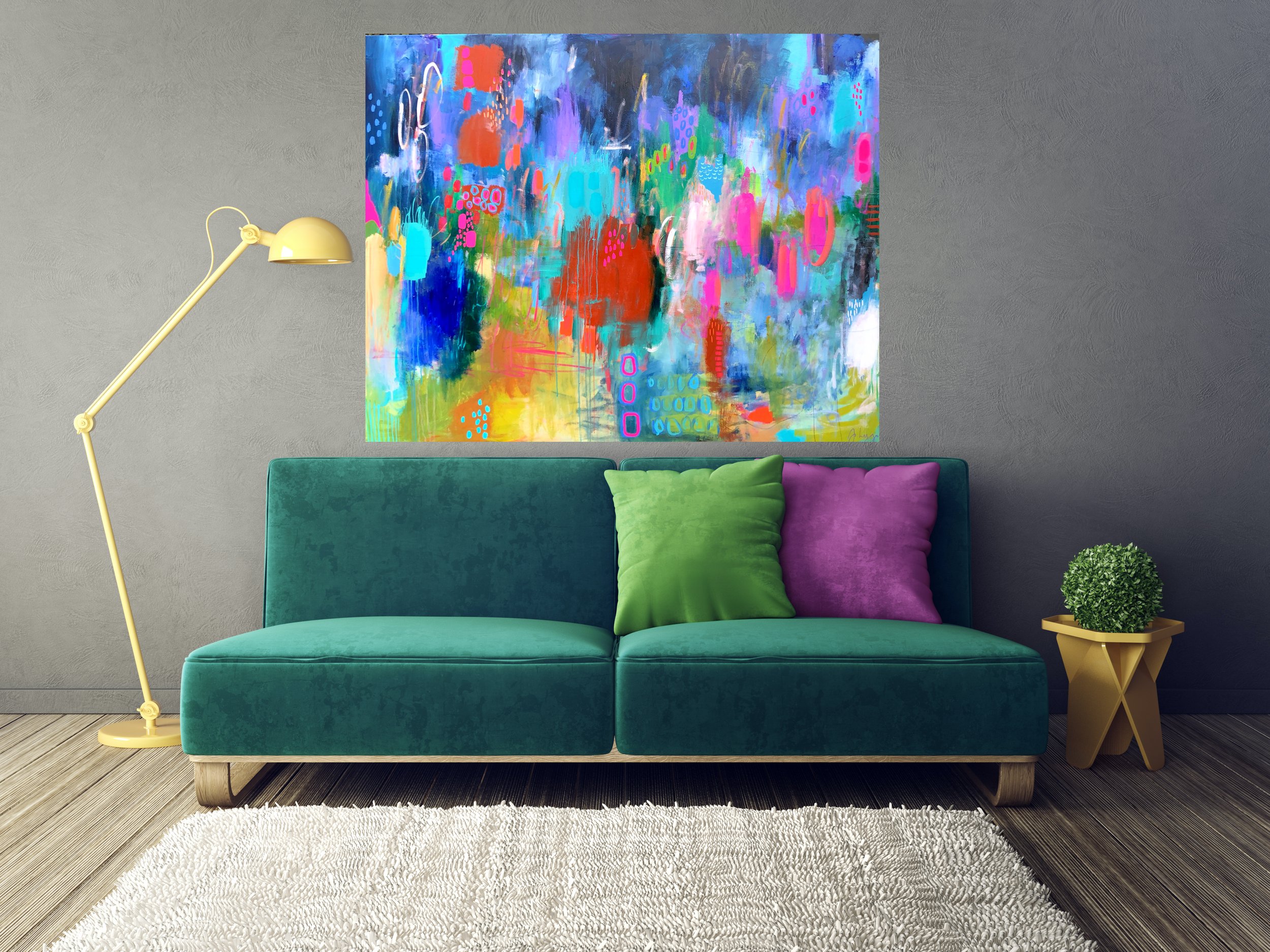 A teal sofa with two colorful pillows, one green and one purple, beside a gold side table with a small green plant. Behind the sofa, an abstract colorful painting hangs on a gray wall. To the left, a yellow floor lamp with an adjustable arm is presen