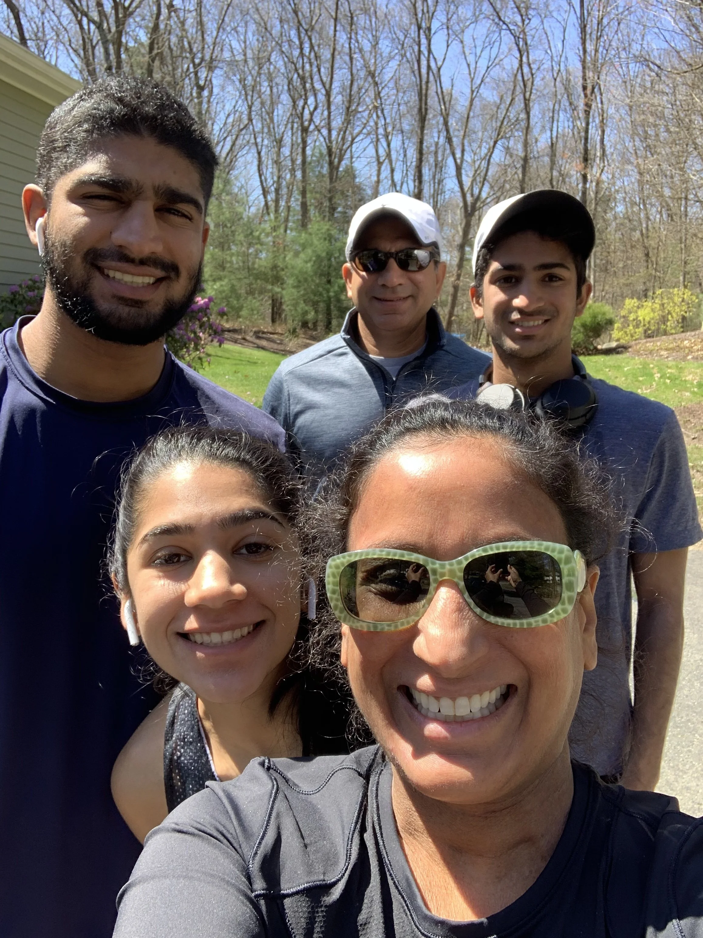 5 people wearing athletic clothes and smiling while posing for selfy