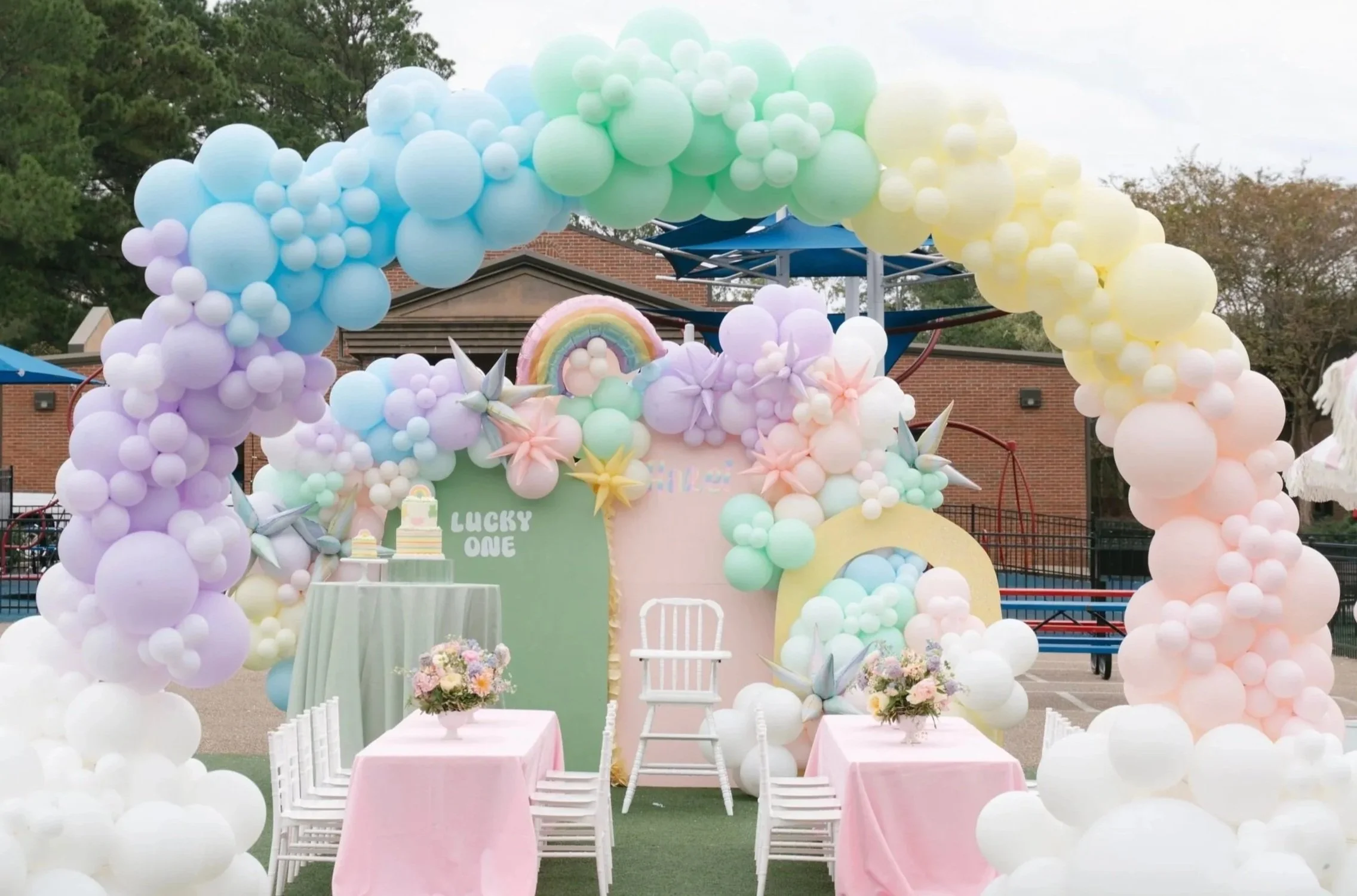 Pastel rainbow balloon garland and backdrop arch for birthday party in Madison, Mississippi.