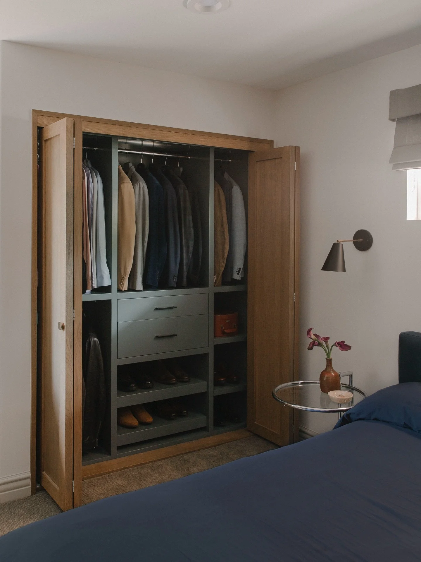 Tired of not being able to see his clothing and shoe options clearly, this client in Los Angeles requested a much more inviting and inspiring closet. Not one, but 2 actually&mdash;that flank either side of his bed. The bar for his suit jackets was up