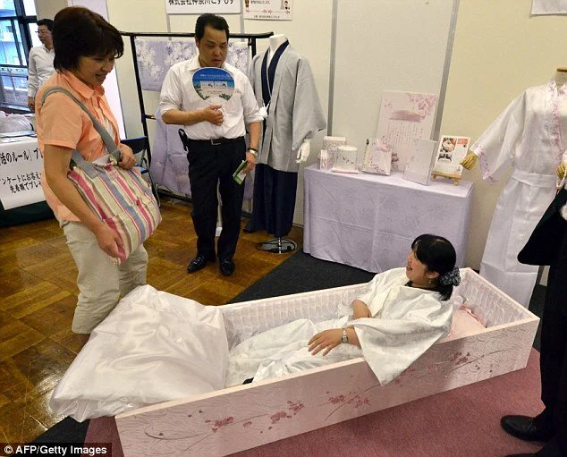 1410428555673_wps_1_A_woman_lies_in_a_coffin_.jpg
