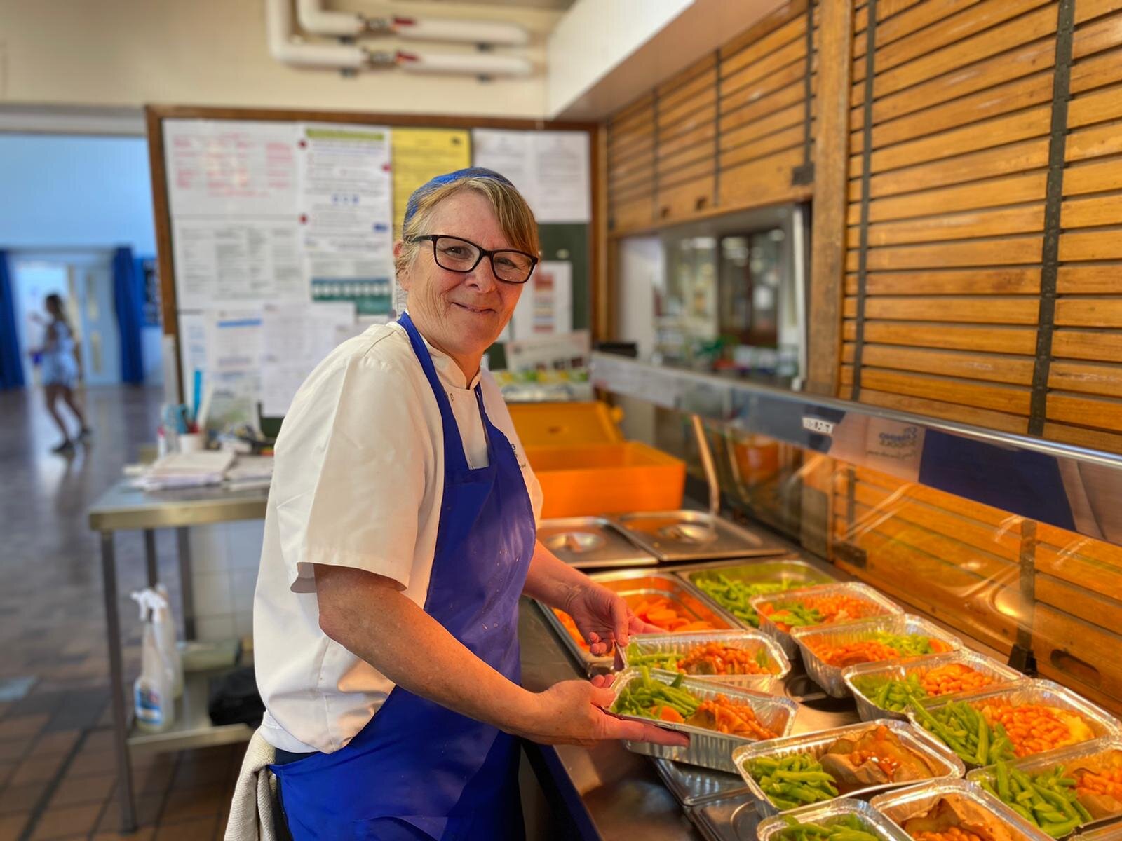 Sharon, dishing up meals ready for transport to HAF funded clubs in the city