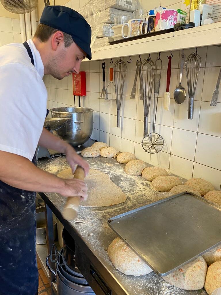 Michael, making pizza bases ready for HAF activities.jpeg
