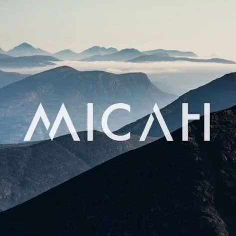 Stylized mountain landscape with fog and the word 'MICAH' in bold white letters.