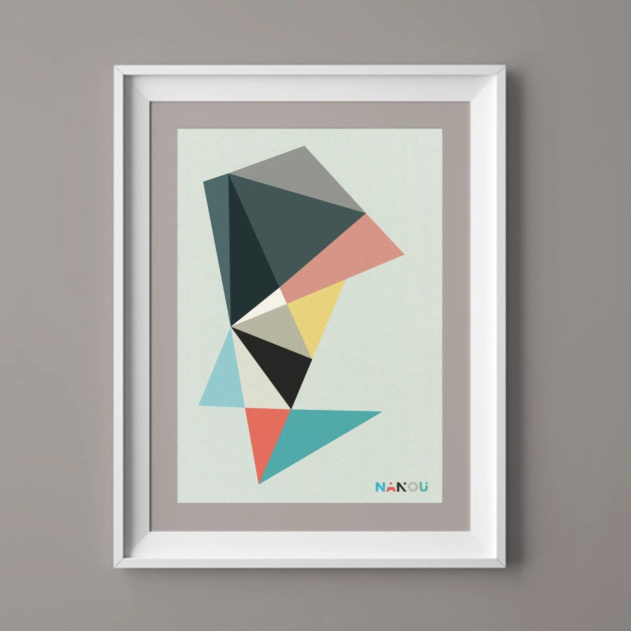 Framed abstract geometric artwork with colorful shapes on a gray wall, with the 'NāNou' logo at the bottom.
