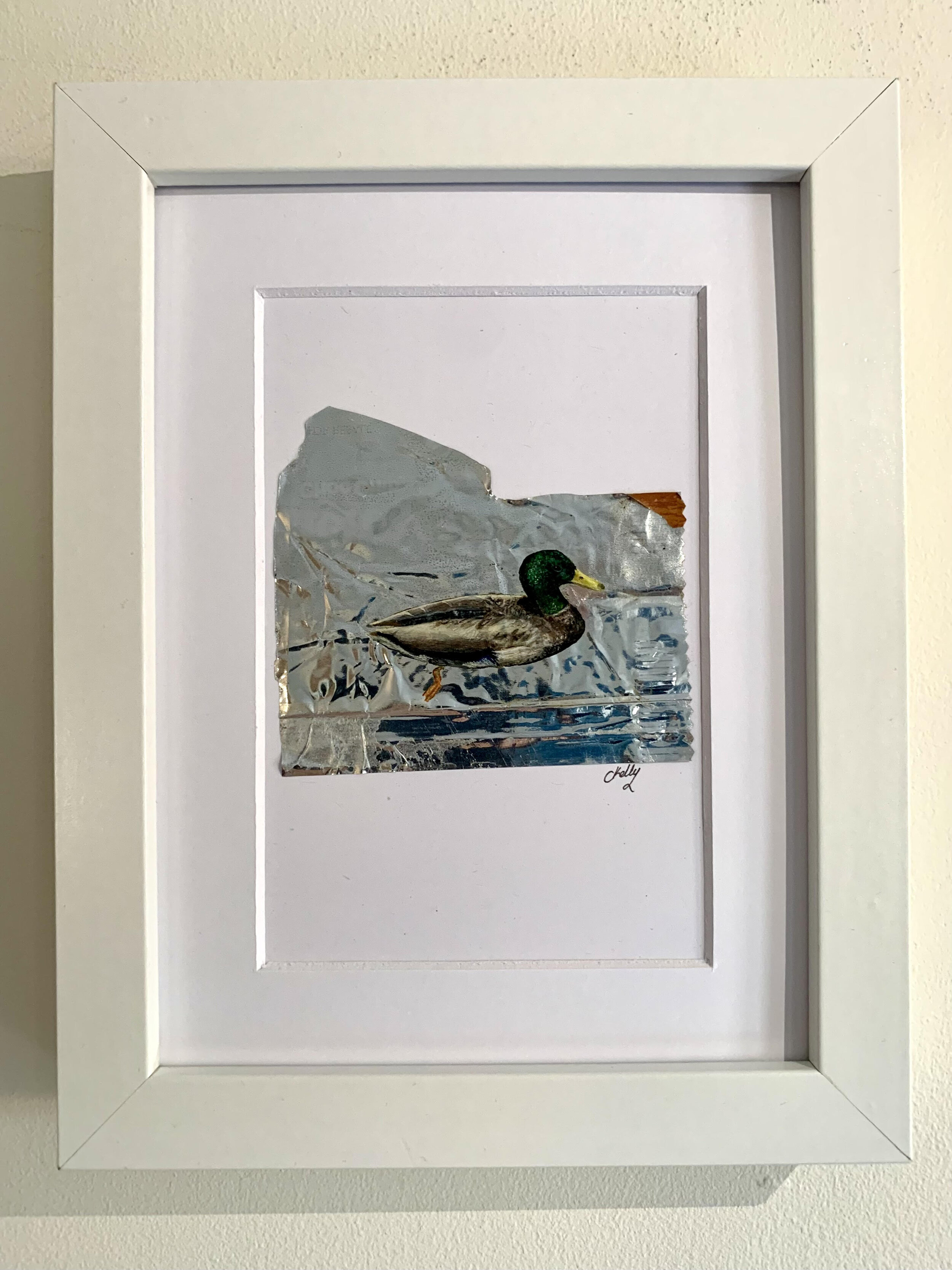 Framed image of a Duck painting on litter