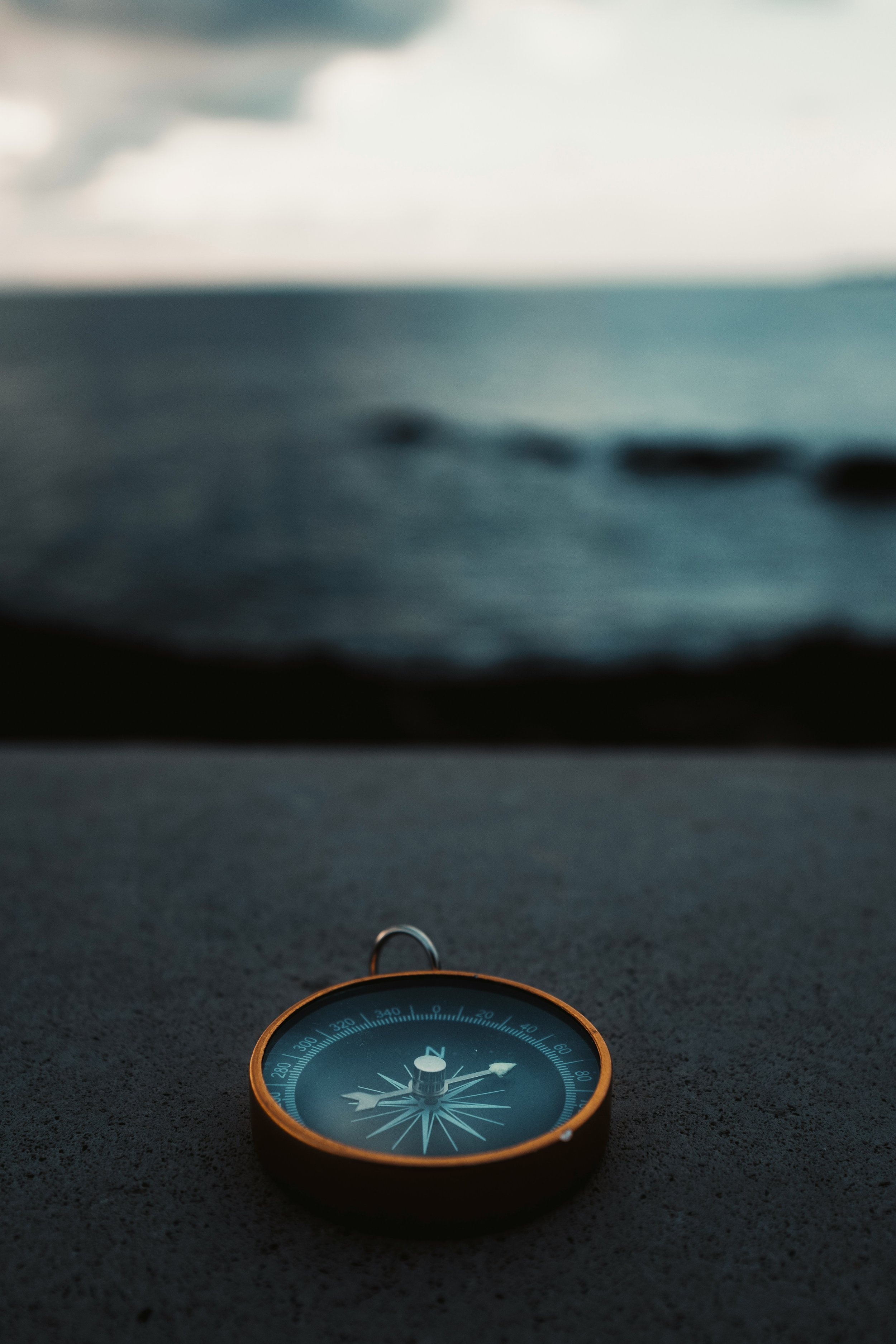 Compass against a dark seascape symbolizing the power of experienced guidance when navigating the complexities of fertility treatment