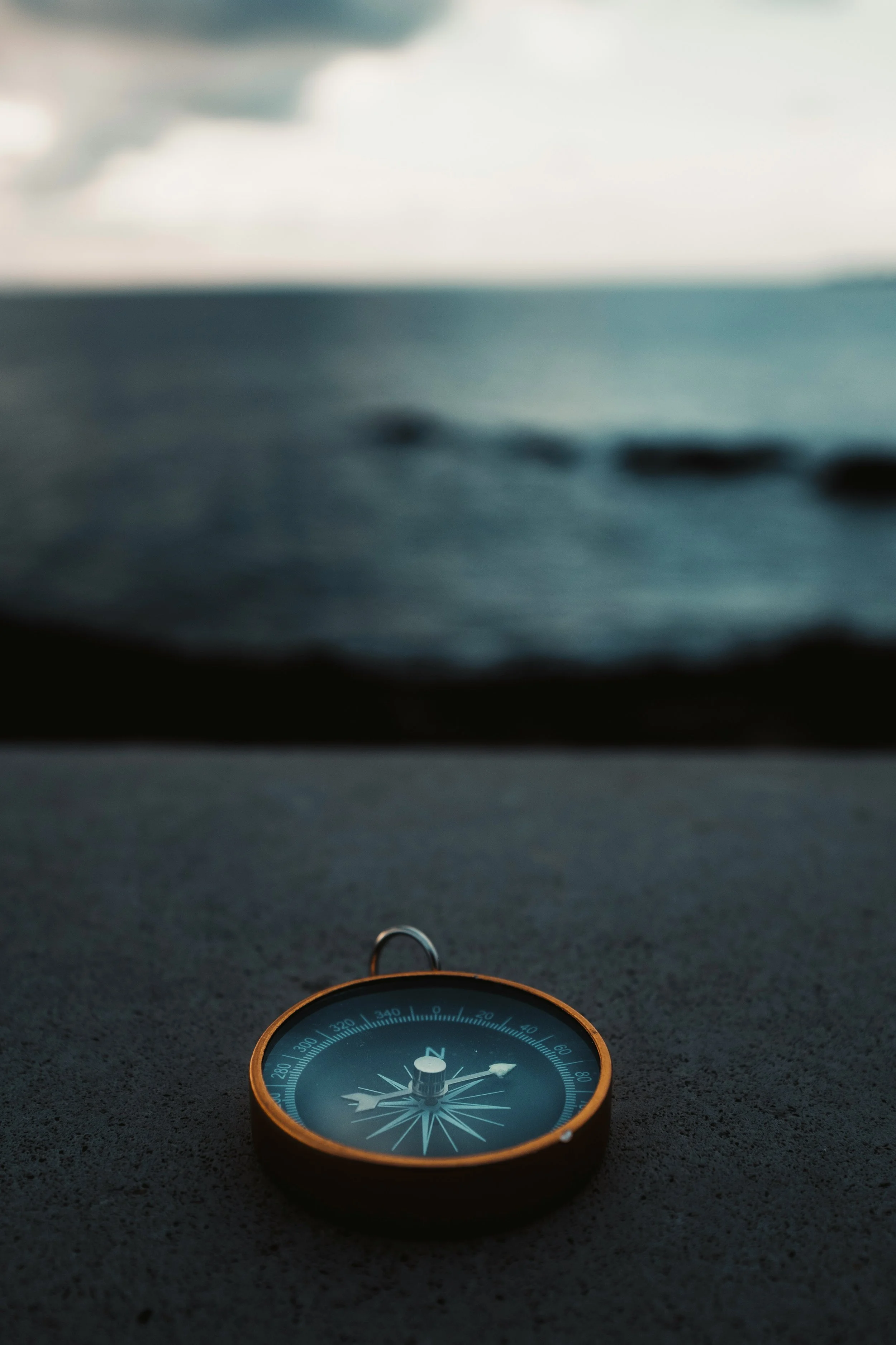 Compass near the ocean representing guidance and direction in fertility care at Fertile Earth Encinitas