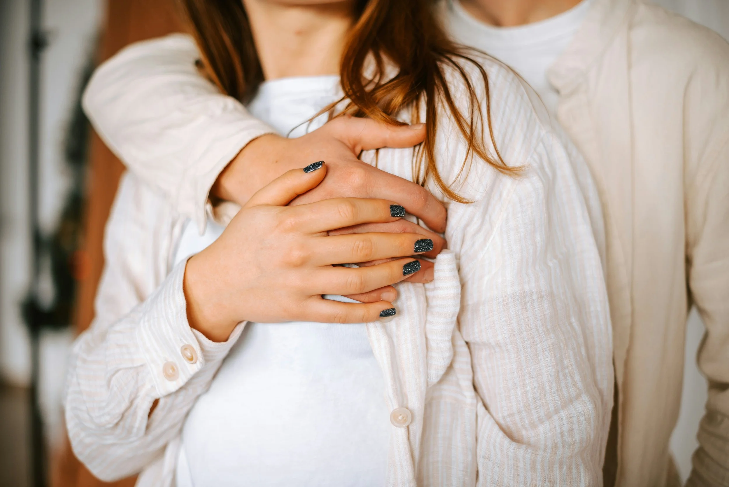 Woman embraced by man calmly representing acupuncture support during IVF at Fertile Earth in Encinitas CA