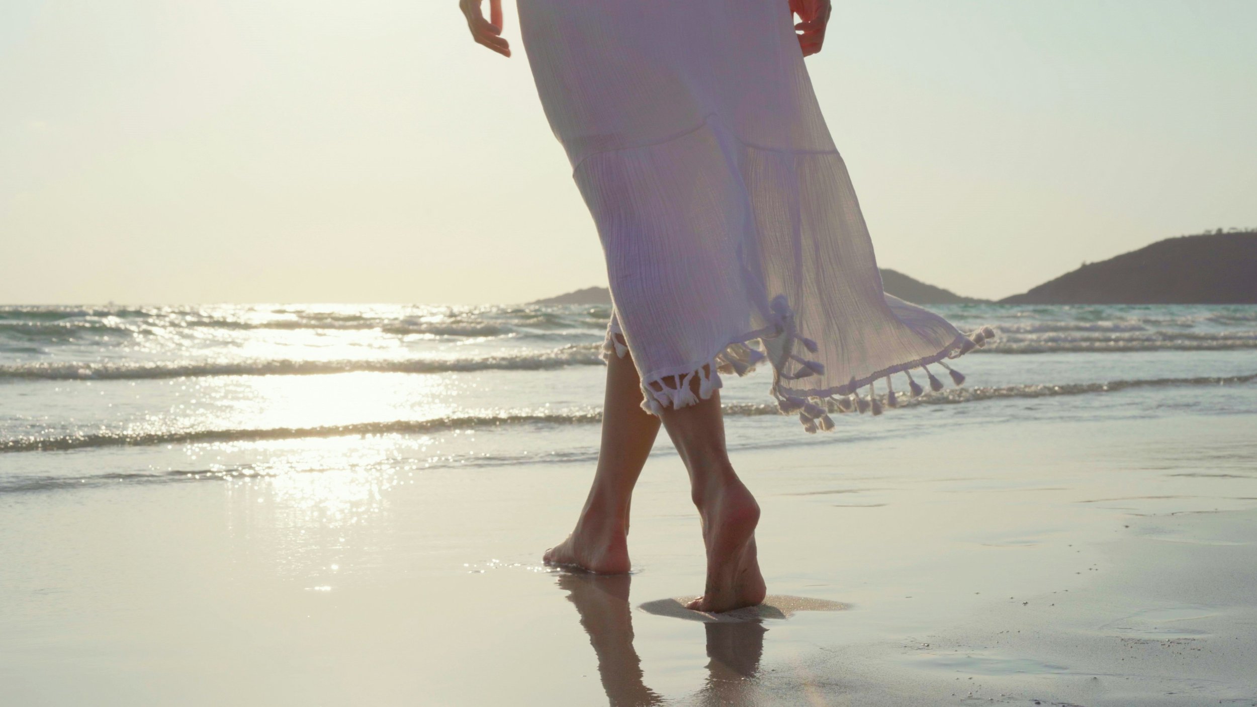 Woman walking barefoot along the shoreline, symbolizing steady recovery after recurrent pregnancy loss — North County San Diego fertility care Image title: Recurrent Pregnancy Loss Care — North County San Diego
