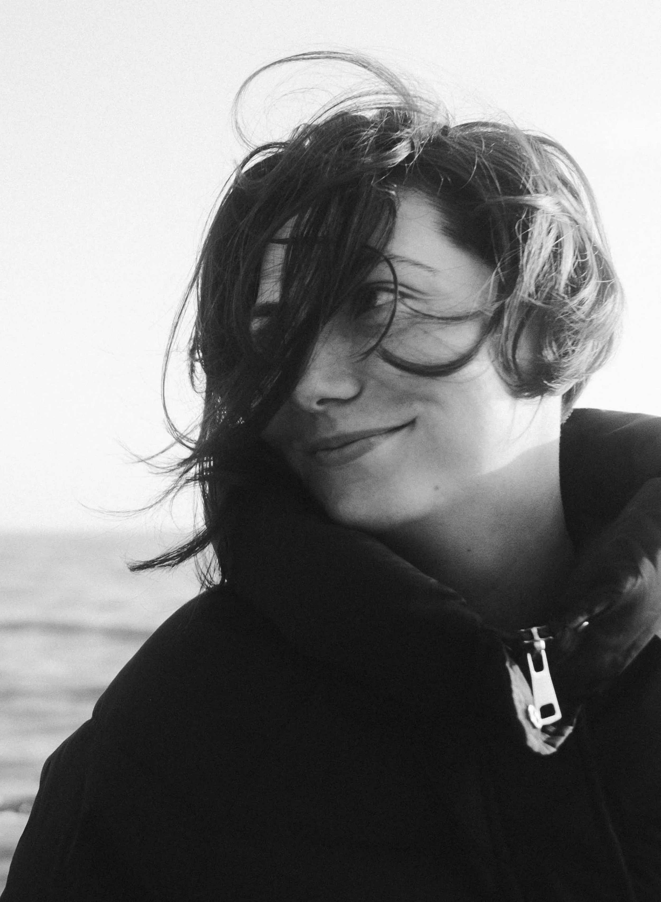 Woman at the coast in soft light, reflecting endometriosis fertility acupuncture support in North County San Diego