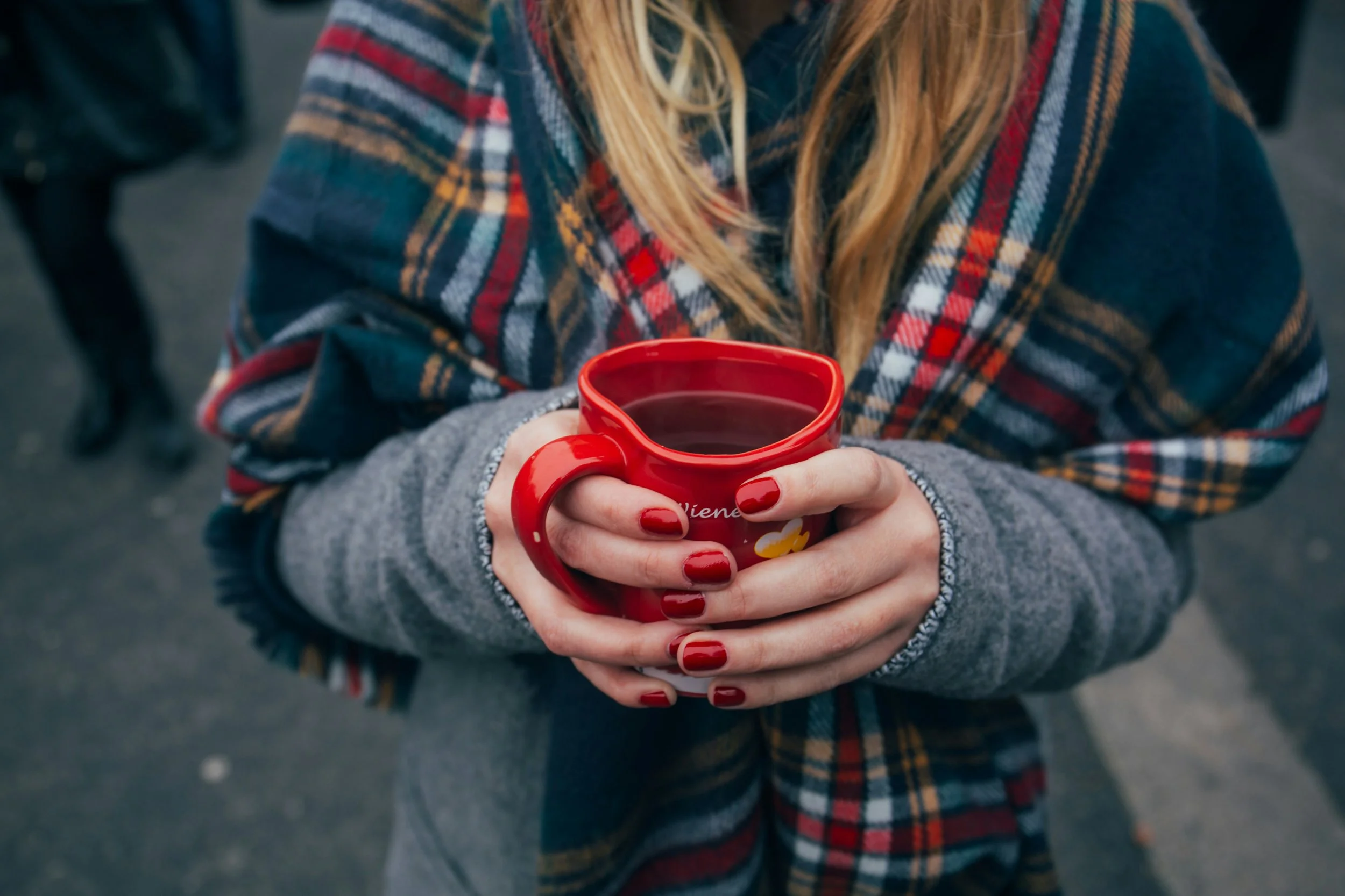 Woman holding tea cup reflecting on her fertility care options in Encinitas