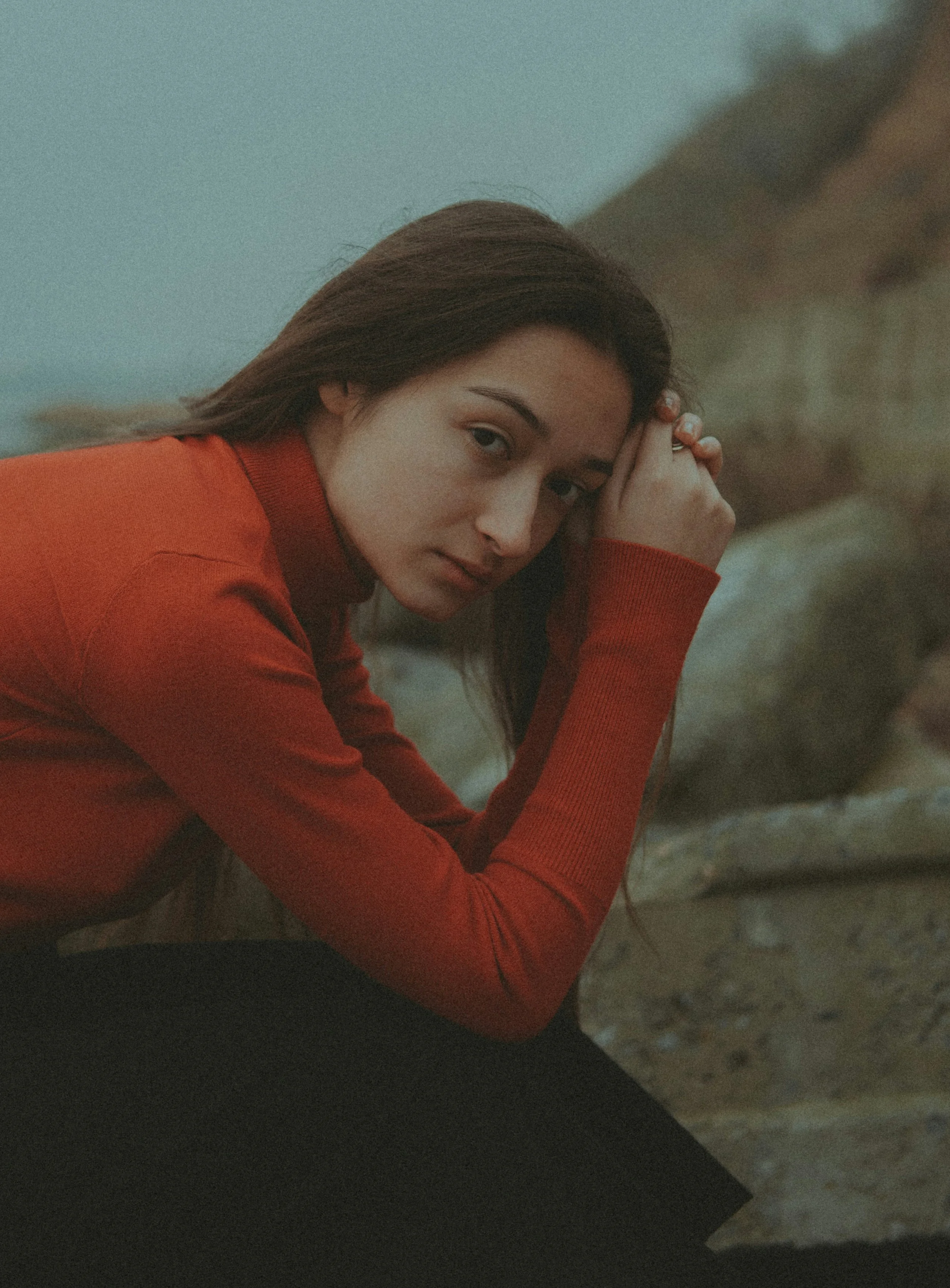 Woman sitting quietly outdoors, representing the weight of living with endometriosis — Fertile Earth Encinitas