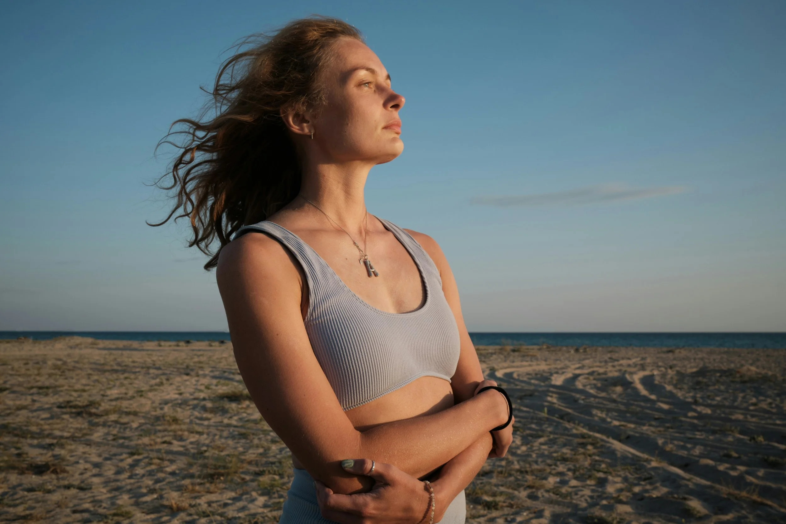 Woman standing on the beach feeling the results of PCOS PMOS fertility treatment at Fertile Earth North County San Diego