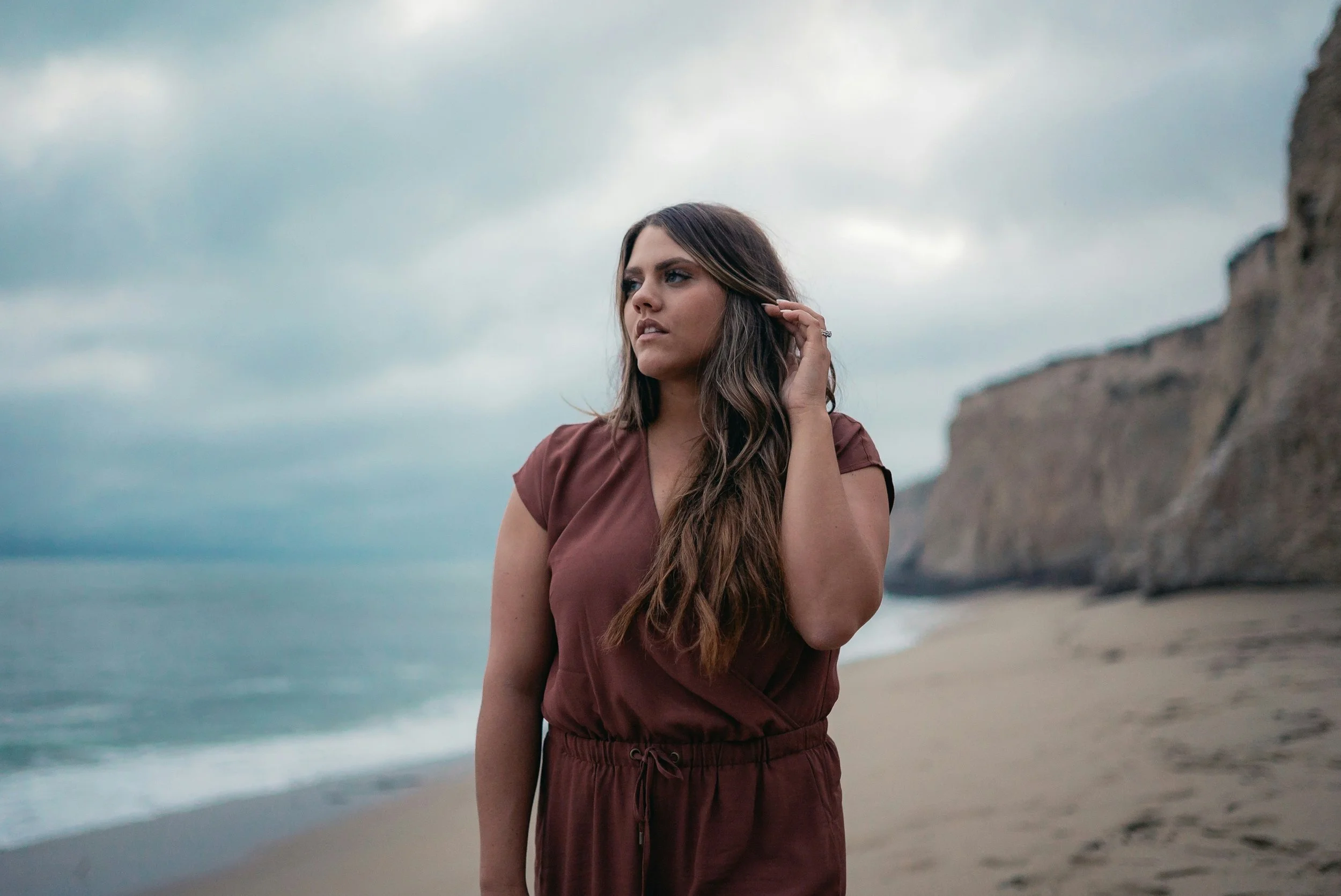 Woman standing on the beach representing two types of PCOS PMOS women seeking fertility treatment at Fertile Earth North County San Diego