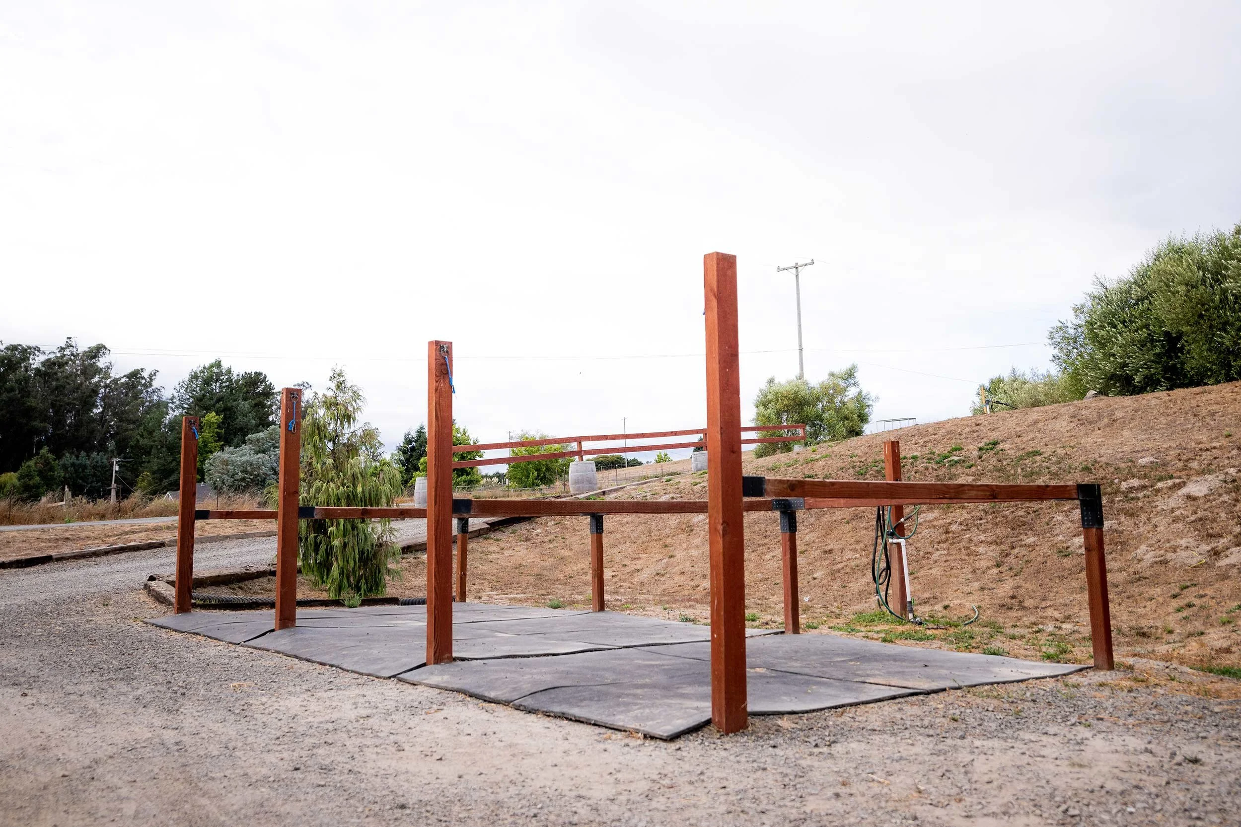 Three outdoor wash racks with rubber mats and crossties