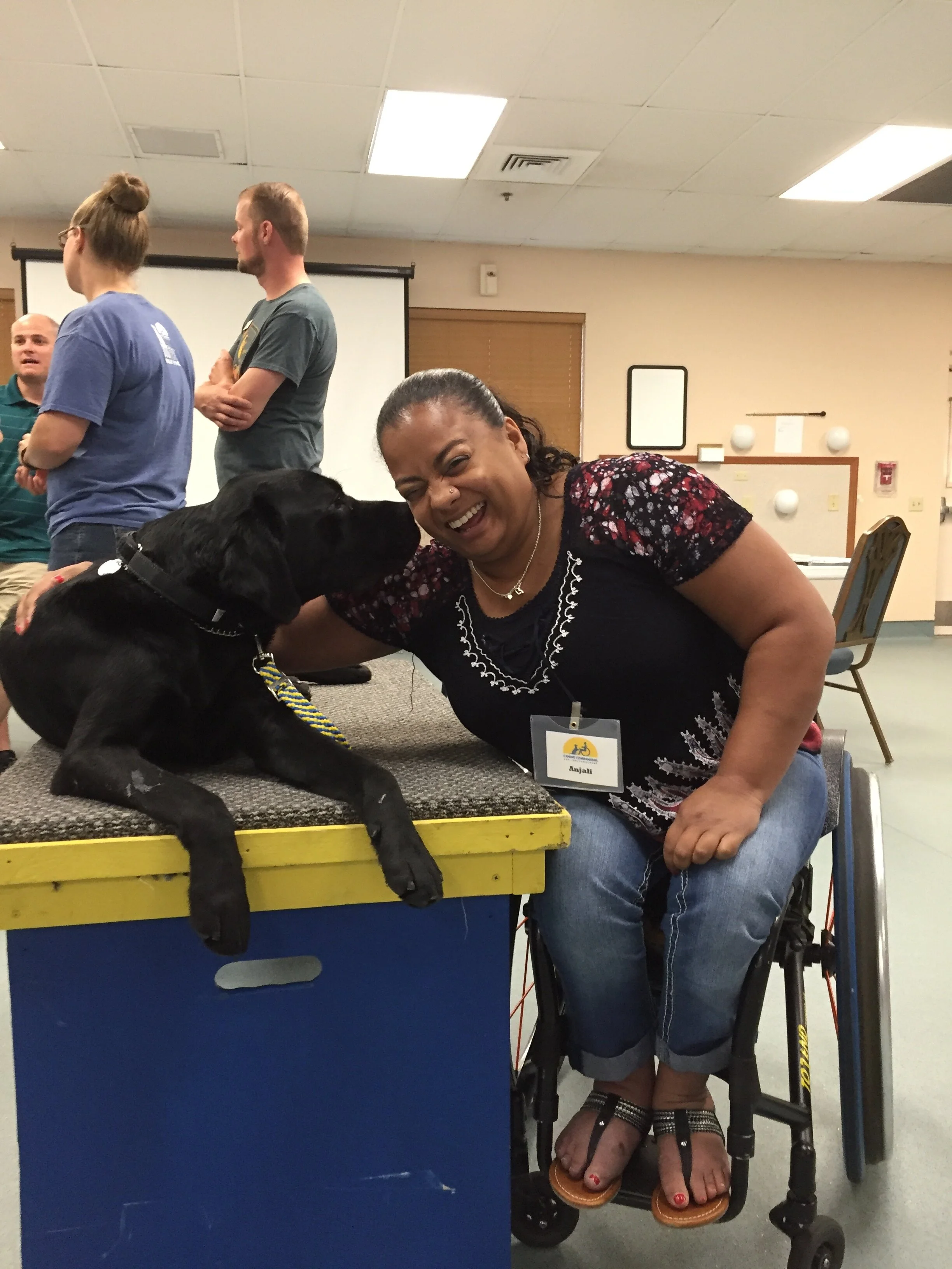 Anjali gets a kiss from Kolton at Canine Companions for Independence. Photo credit: Canine Companions for Independence