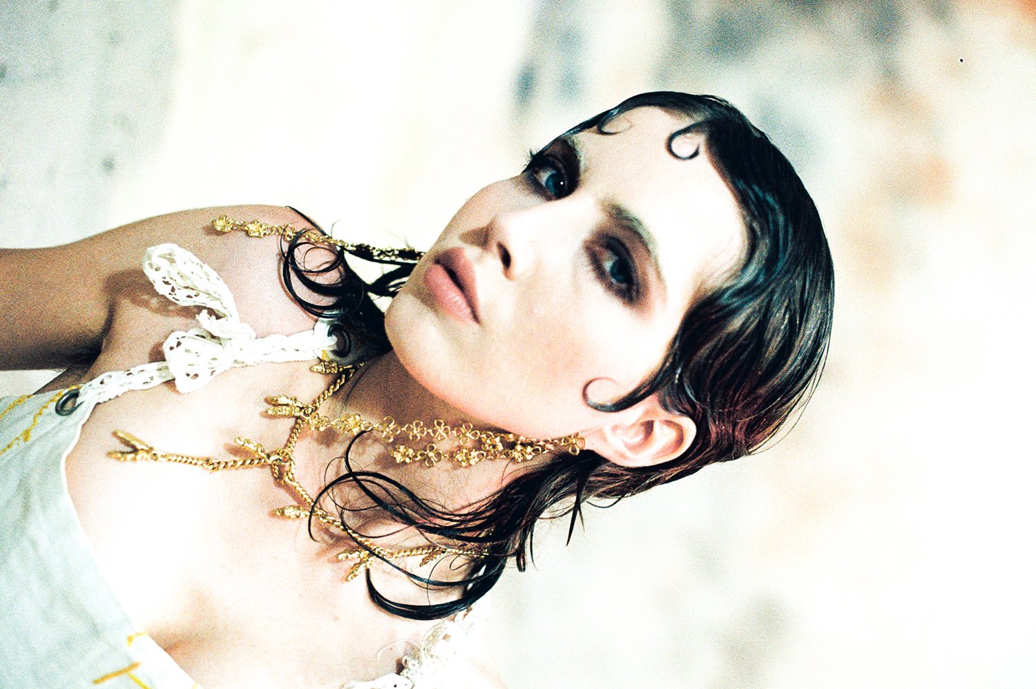 Model wearing heavenly bodies necklace and rosary earrings detail shot