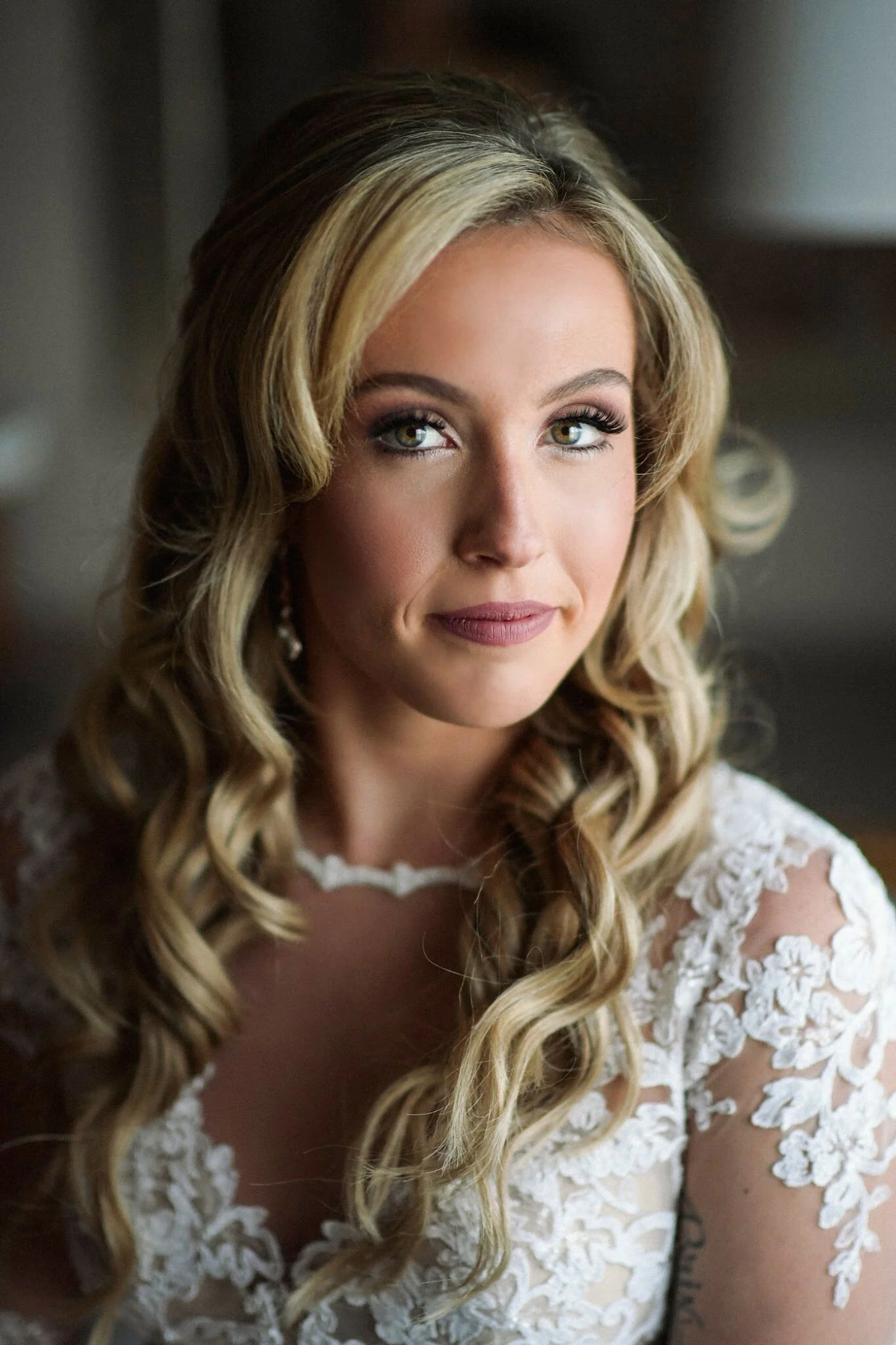 Woman with long blonde hair in a lace bridal dress