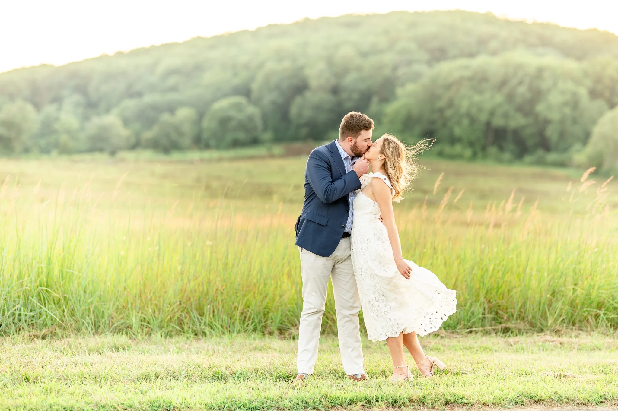 As Melanie and Thomas settled into a cozy seated pose beside the National Memorial Arch in King of Prussia, PA, I gently arranged Melanie&rsquo;s hair for the sweet engagement photo I was about to take. The wind, however, had other plans and swept it