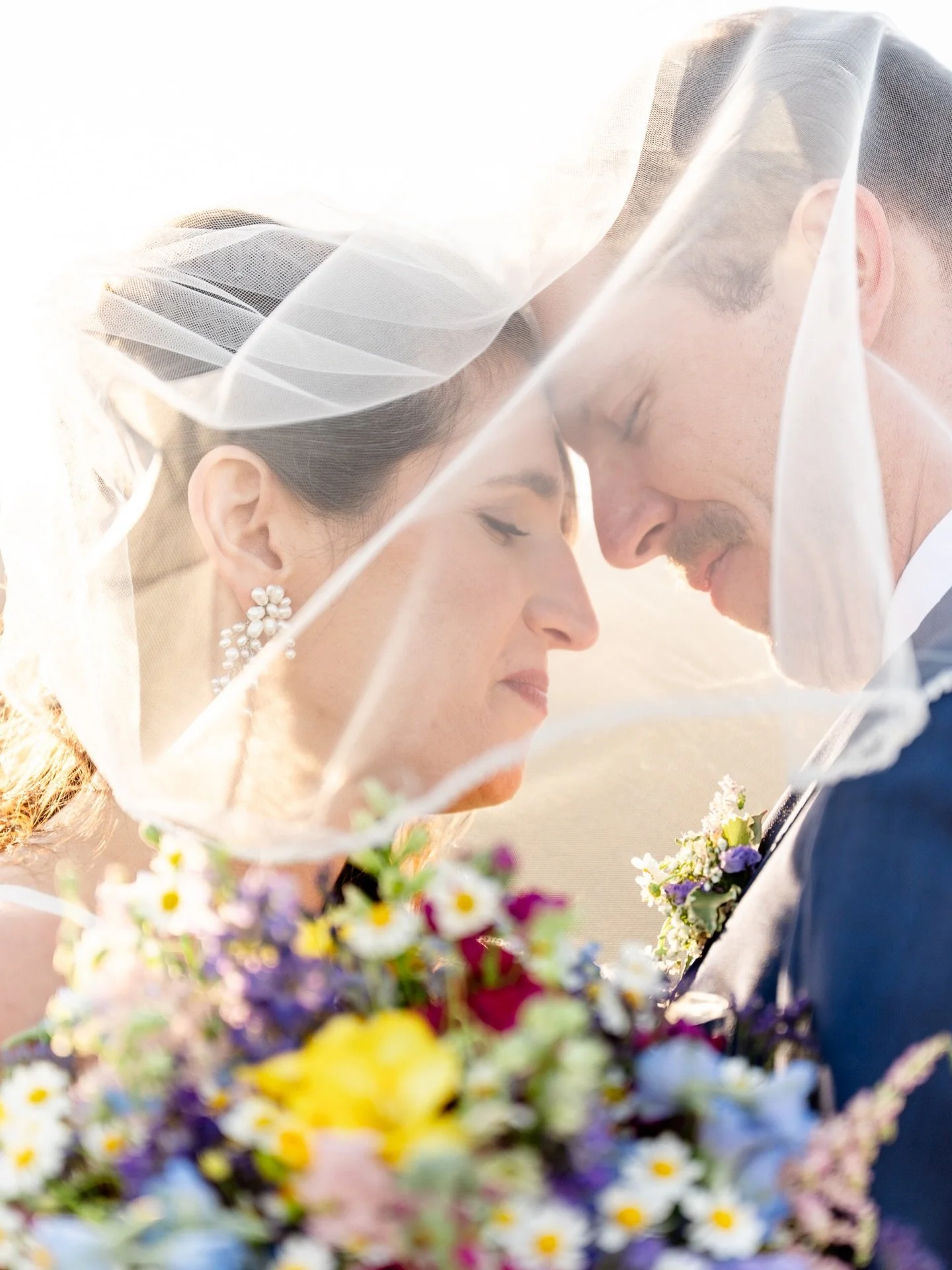 Sara and John had the outdoor spring wedding of their dreams at Springfield Manor in Thurmont, Maryland, on Saturday. The flowers by Blossom and Basket Boutique looked like a springtime celebration with their vibrant colors, and the trees behind the 